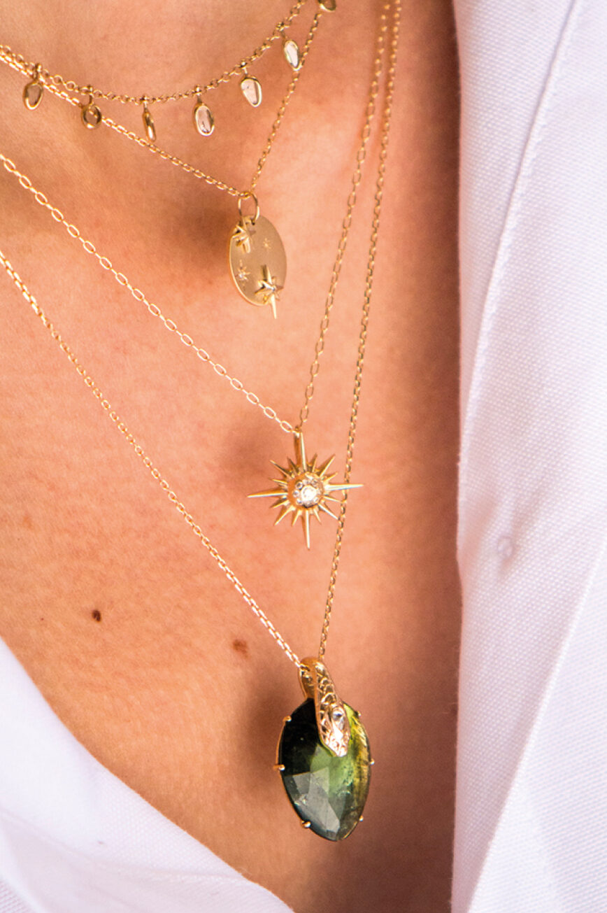 Yellow gold necklace sculpted sun ray pendant diamond center delicate chain Celine Daoust