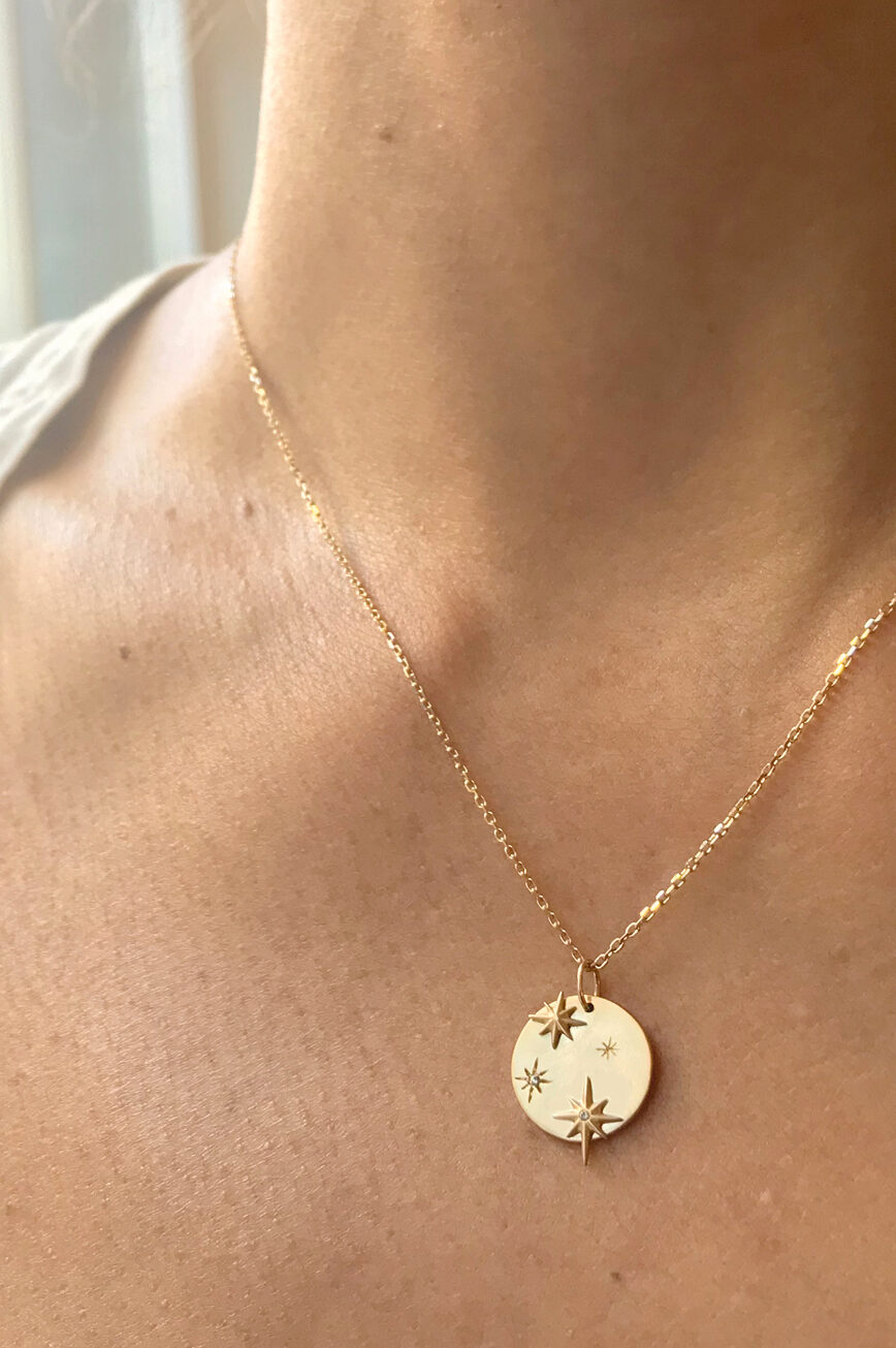 Yellow gold necklace round medal pendant engraved star motif diamond accents chain Celine Daoust