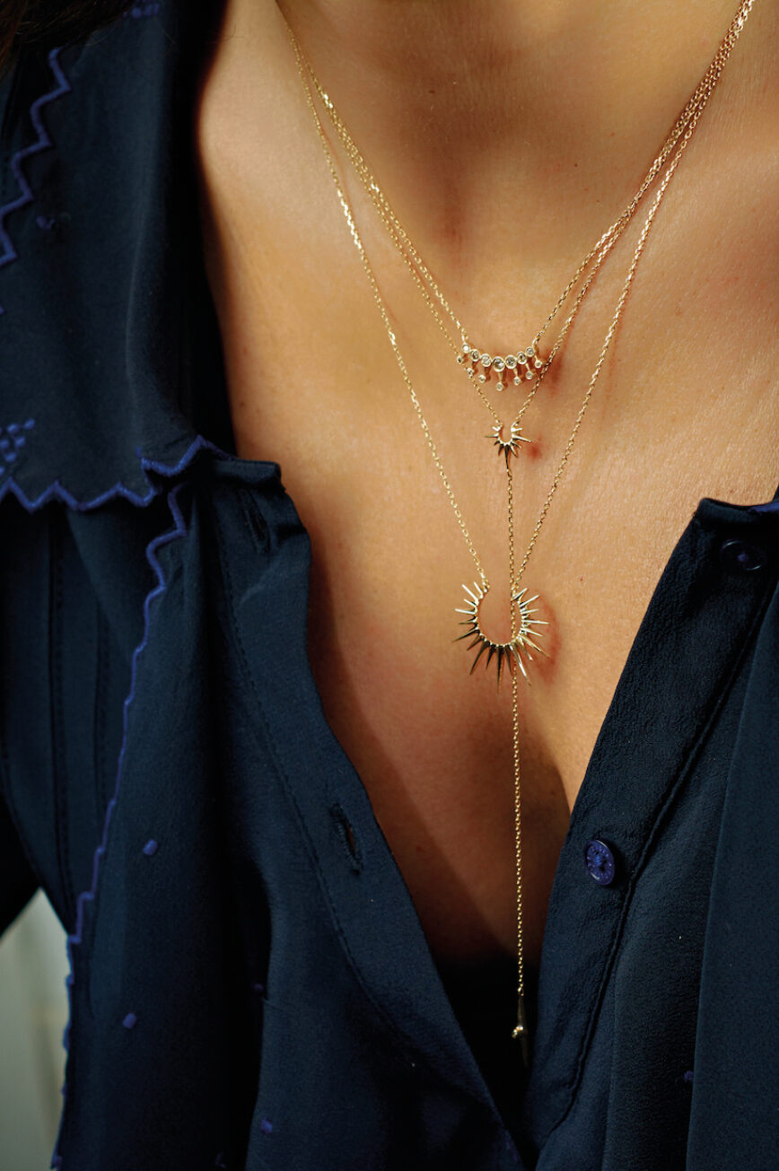 yellow gold lariat necklace with a fine chain ending in a small eight-pointed star pendant set with a round brilliant diamond