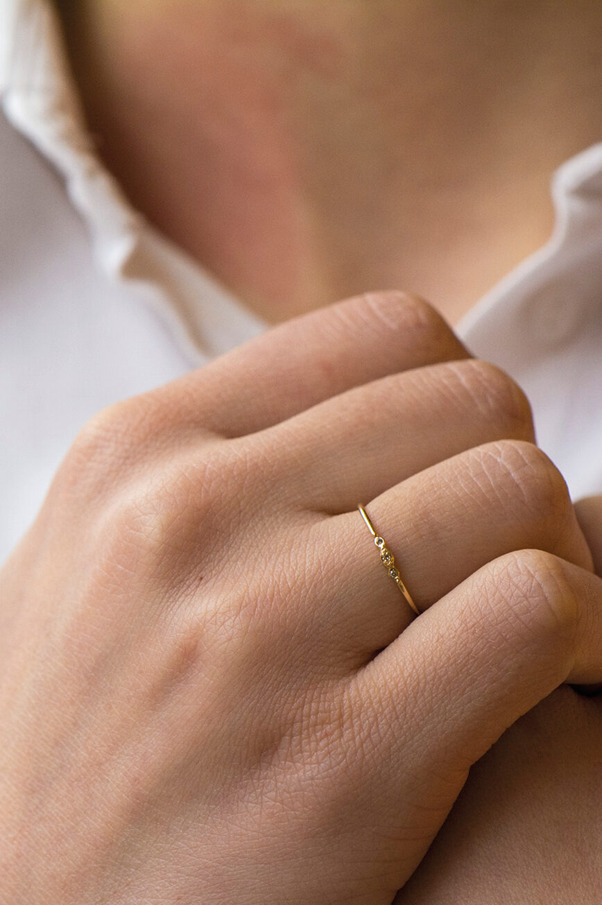 Gold ring three tiny diamonds eye motif slim band Celine Daoust