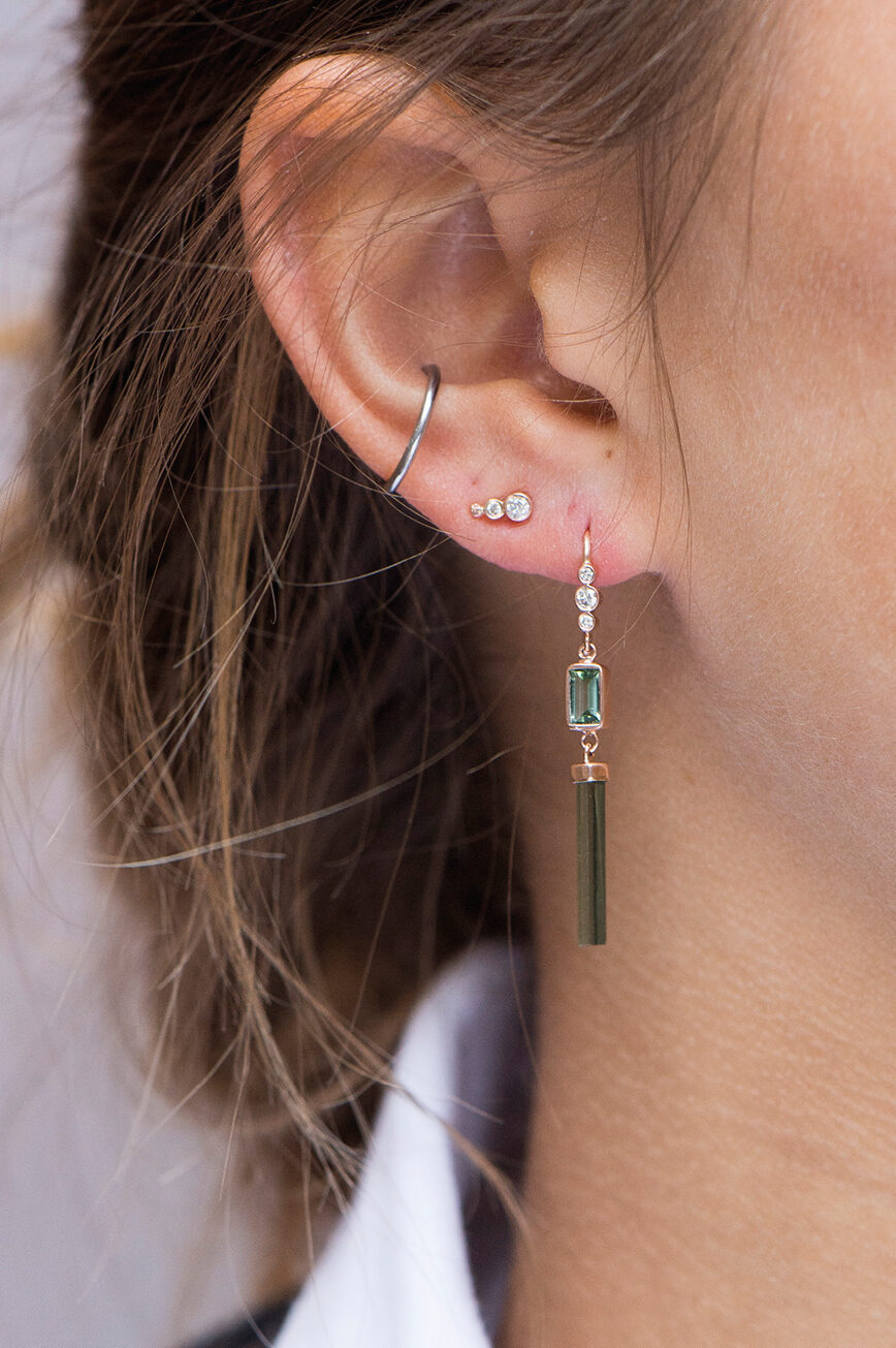 yellow gold drop earrings each with a bezel-set round diamond at top suspending a smaller diamond drop, simple and elegant