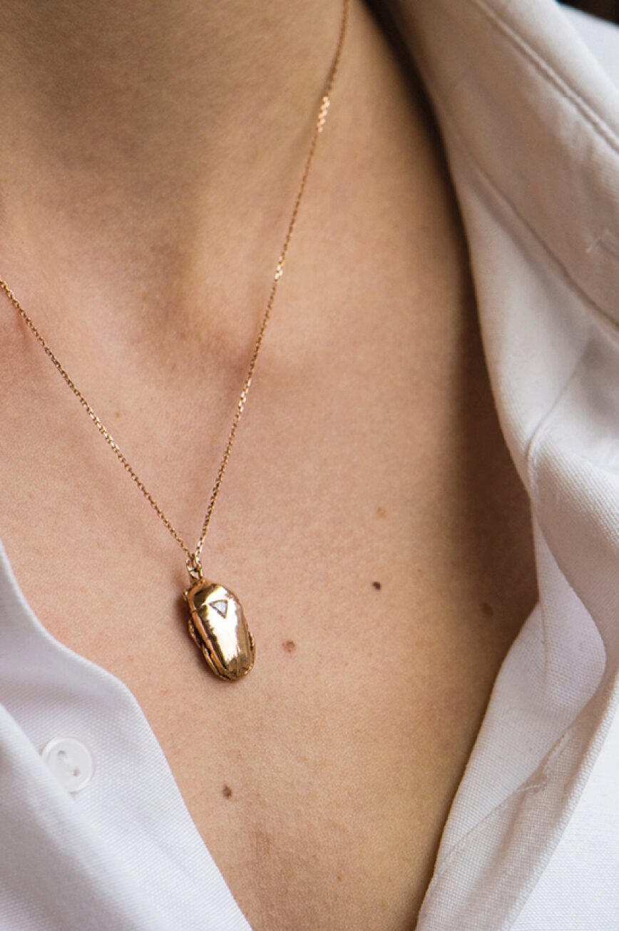 Yellow gold necklace sculpted scarab pendant trillion diamond accent chain Celine Daoust