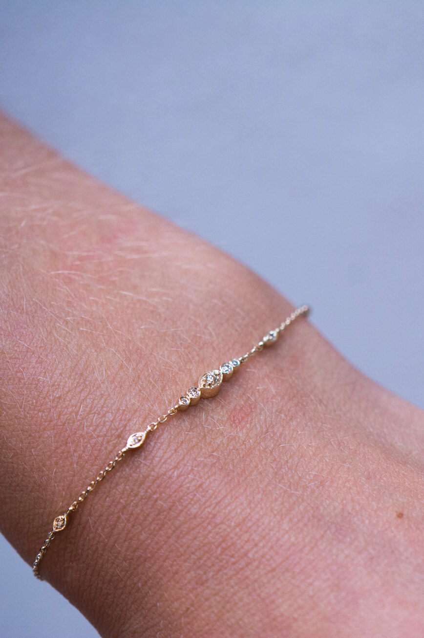 Gold chain bracelet small eye motif diamond accents Céline Daoust