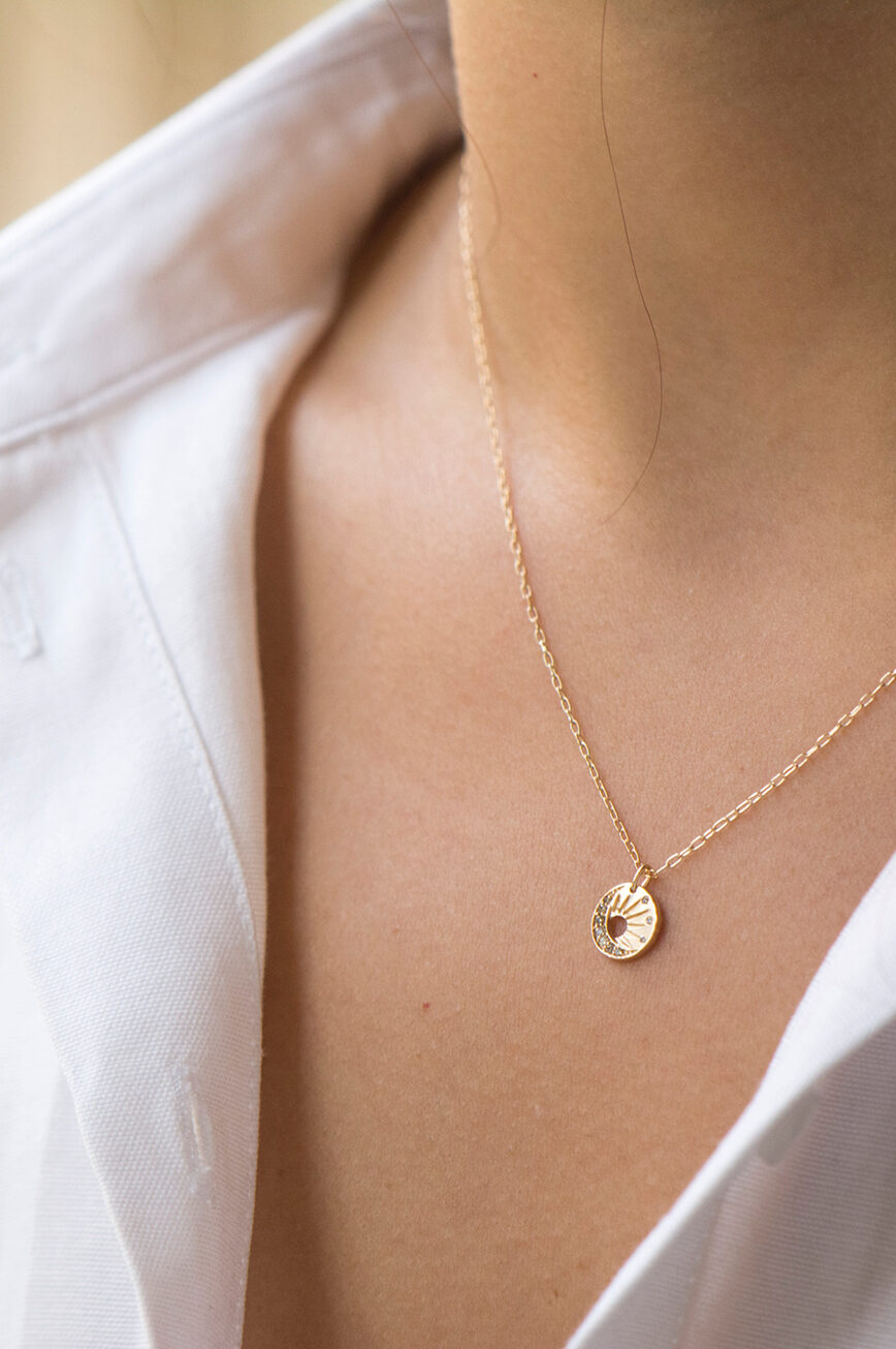 Yellow gold necklace small round medal pendant sun moon motif delicate chain Celine Daoust