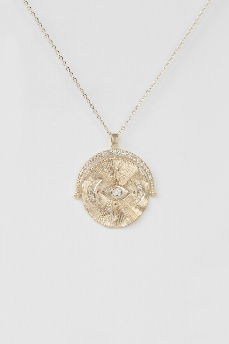 Yellow gold necklace large round medal pendant engraved eye sun diamond accents chain Celine Daoust