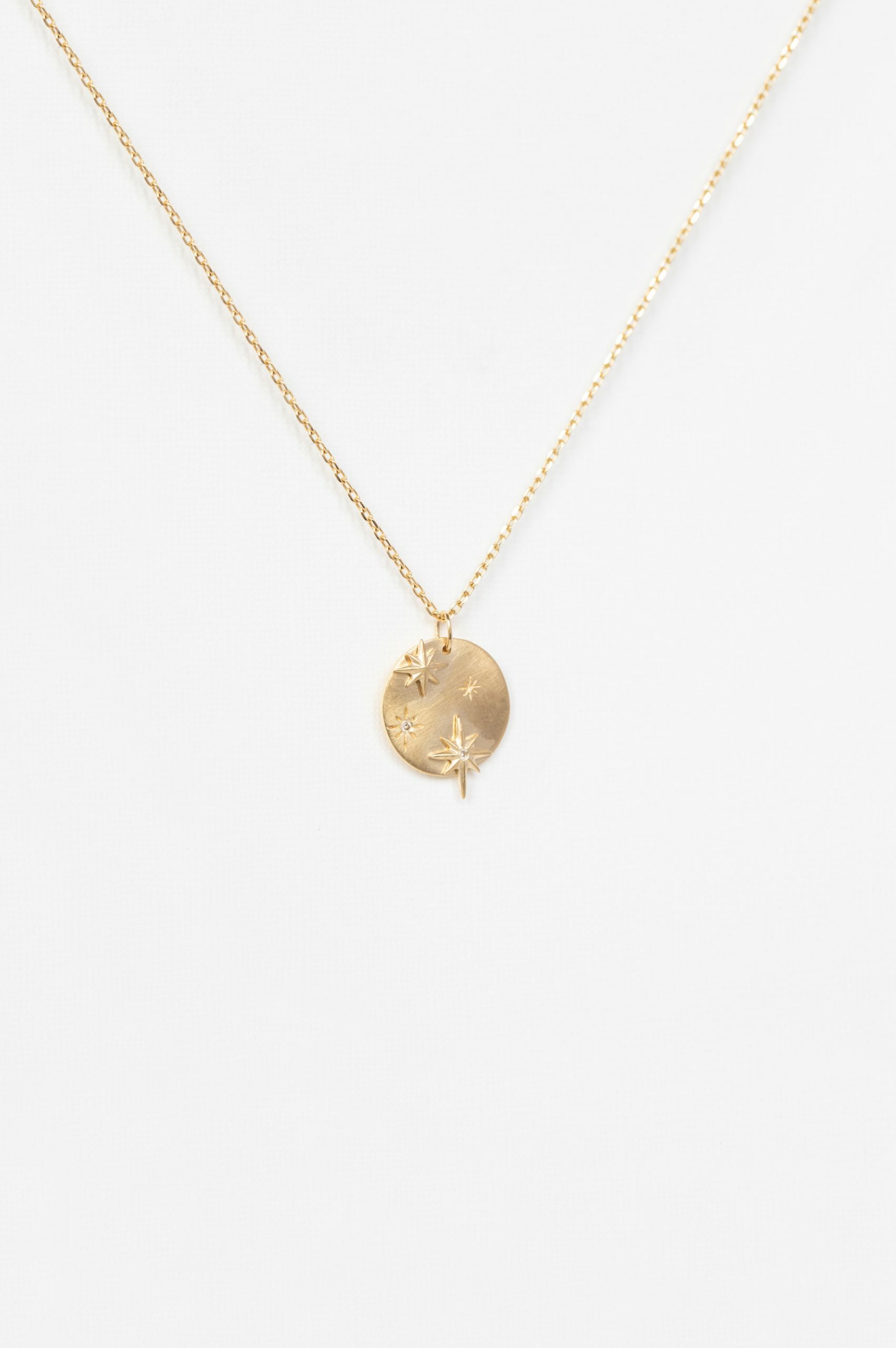 Yellow gold necklace round medal pendant engraved star motif diamond accents chain Celine Daoust