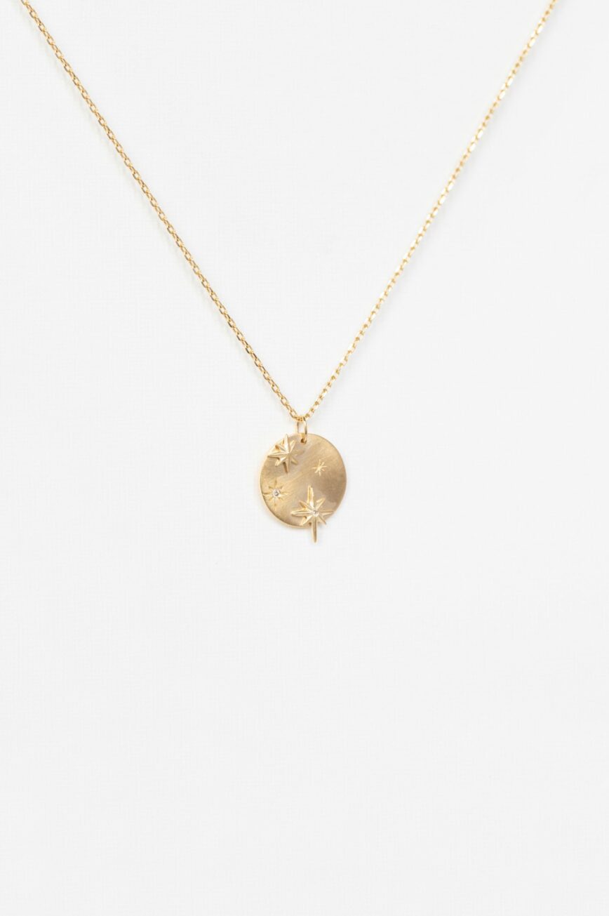 Yellow gold necklace round medal pendant engraved star motif diamond accents chain Celine Daoust