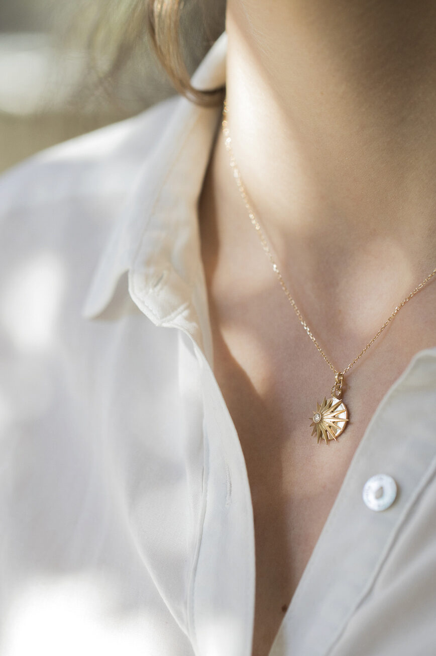 Yellow gold necklace round medal pendant diamond center sun ray motif chain Celine Daoust