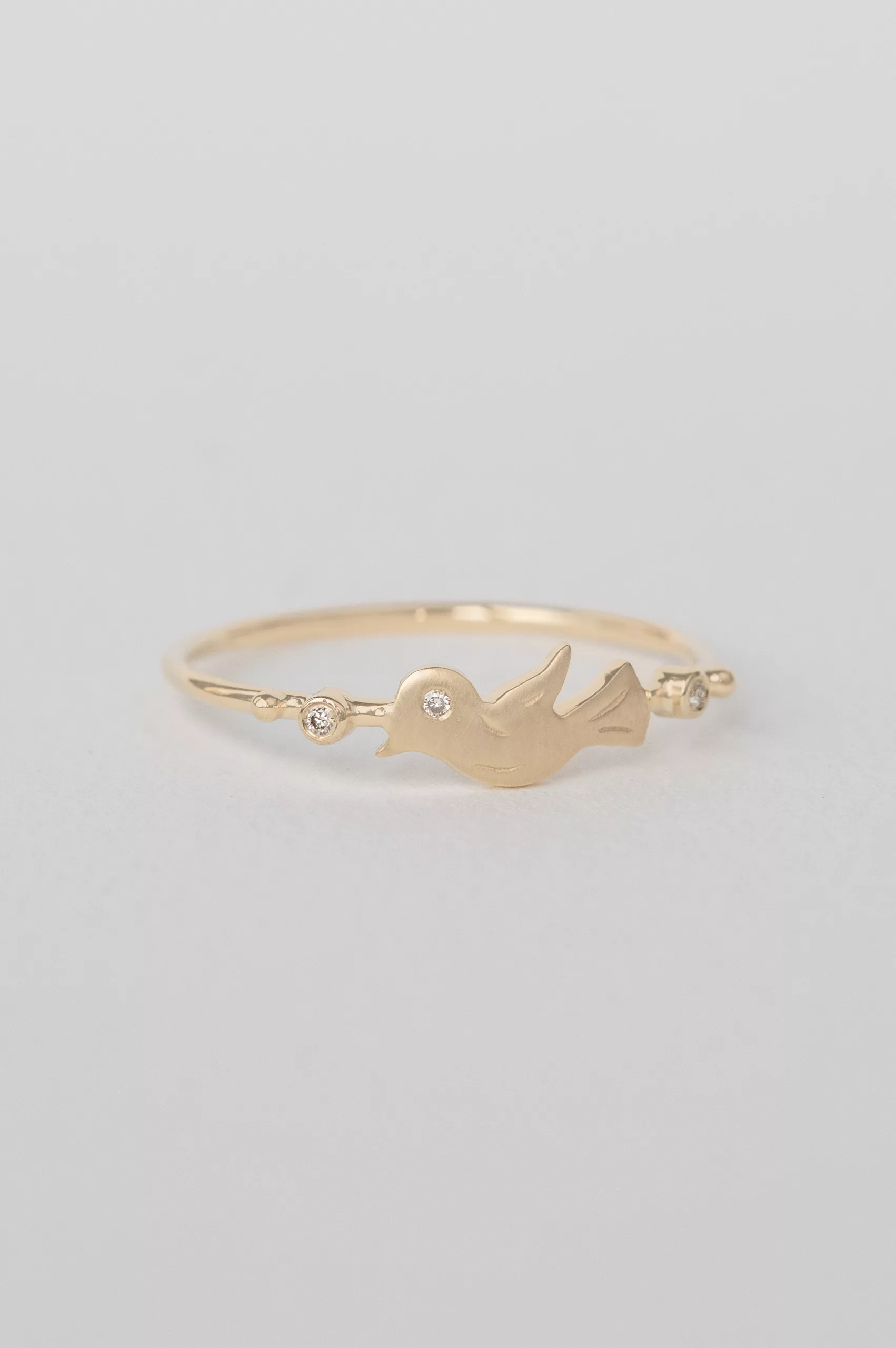 Yellow gold ring sculpted bird motif diamond accent slim band Celine Daoust