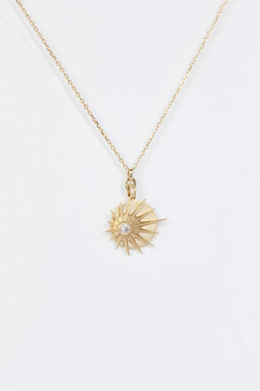 Yellow gold necklace round medal pendant diamond center sun ray motif chain Celine Daoust