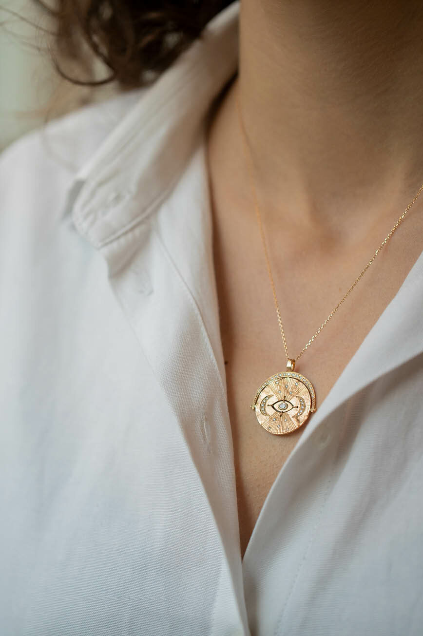 Yellow gold necklace large round medal pendant engraved eye sun diamond accents chain Celine Daoust