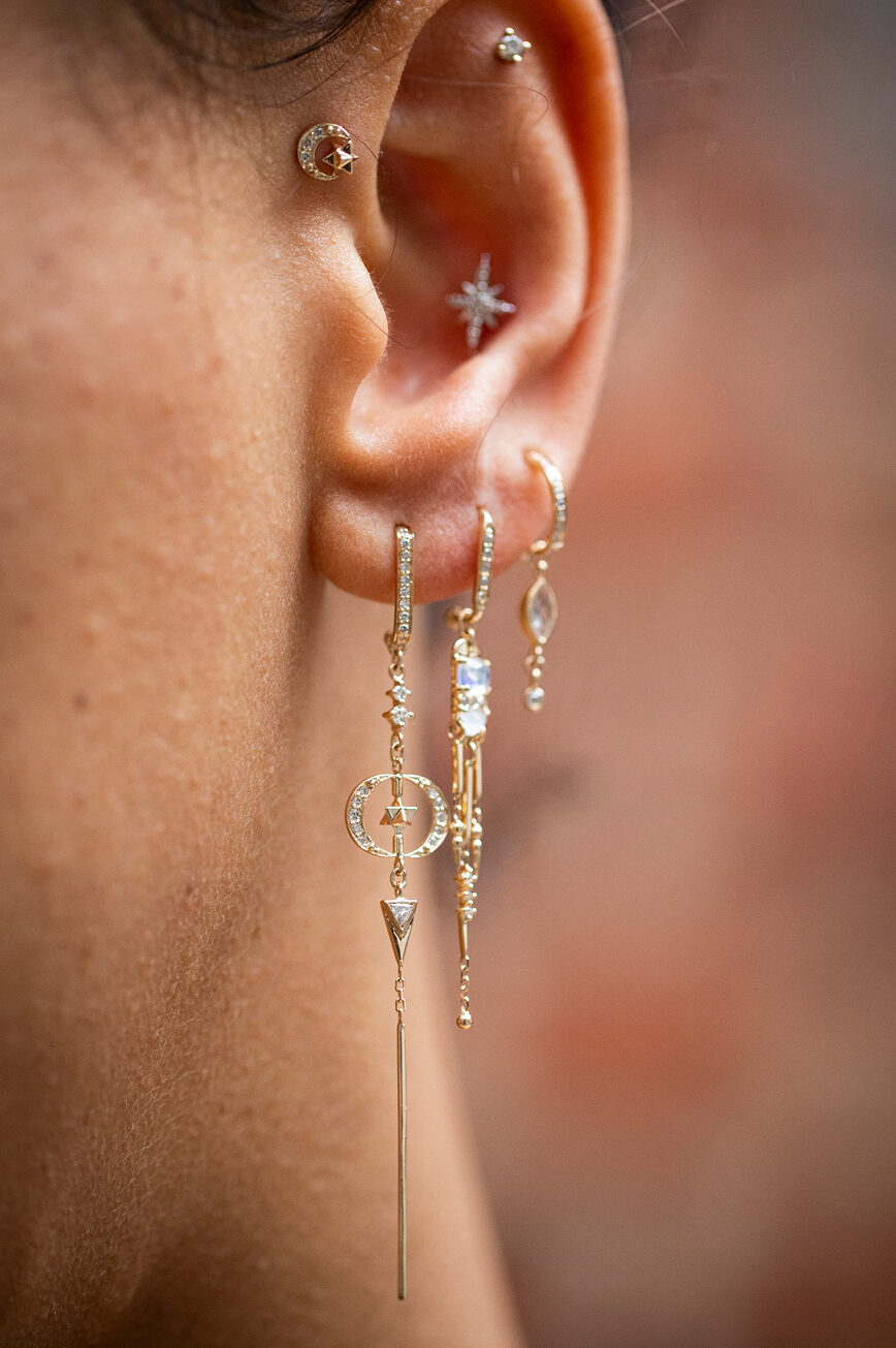Yellow gold long drop earrings moon merkabah diamond charms worn on ear Celine Daoust