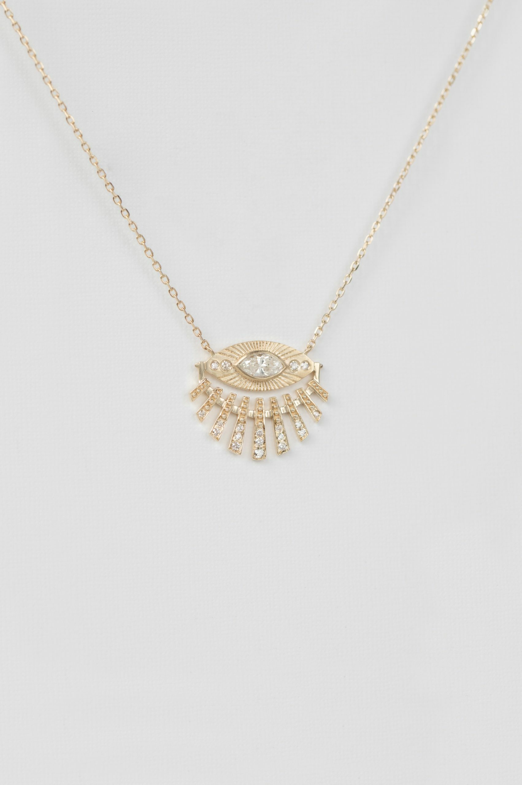 Yellow gold necklace open sun ray eye pendant diamond accents delicate chain Celine Daoust