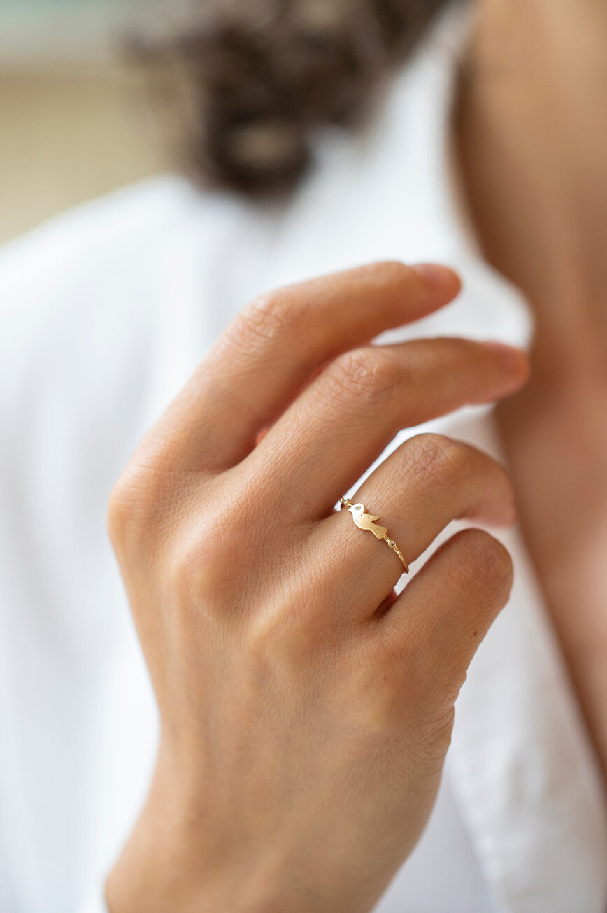 Yellow gold ring sculpted bird motif diamond accent slim band Celine Daoust