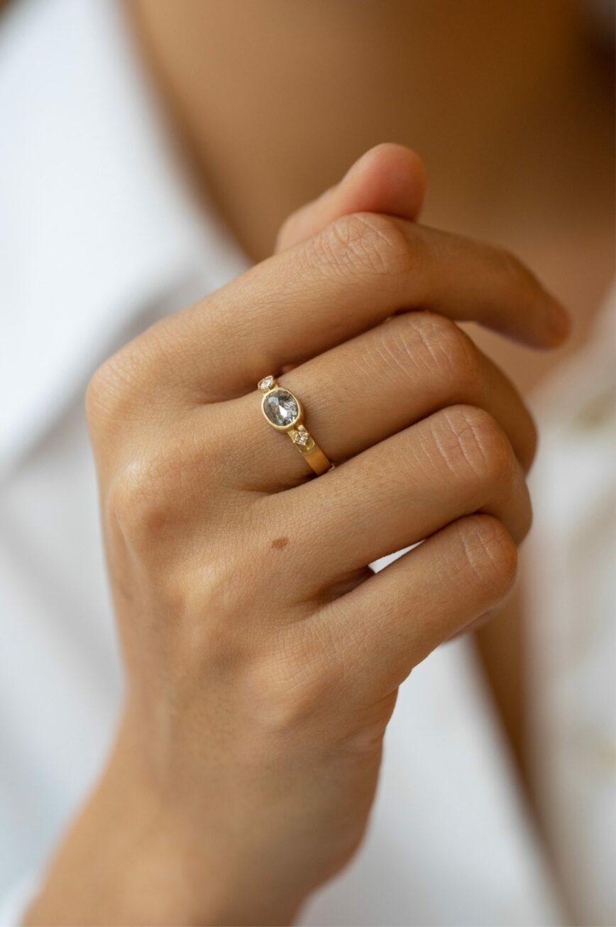 Yellow gold signet ring oval dark grey diamond square diamond side accents Celine Daoust