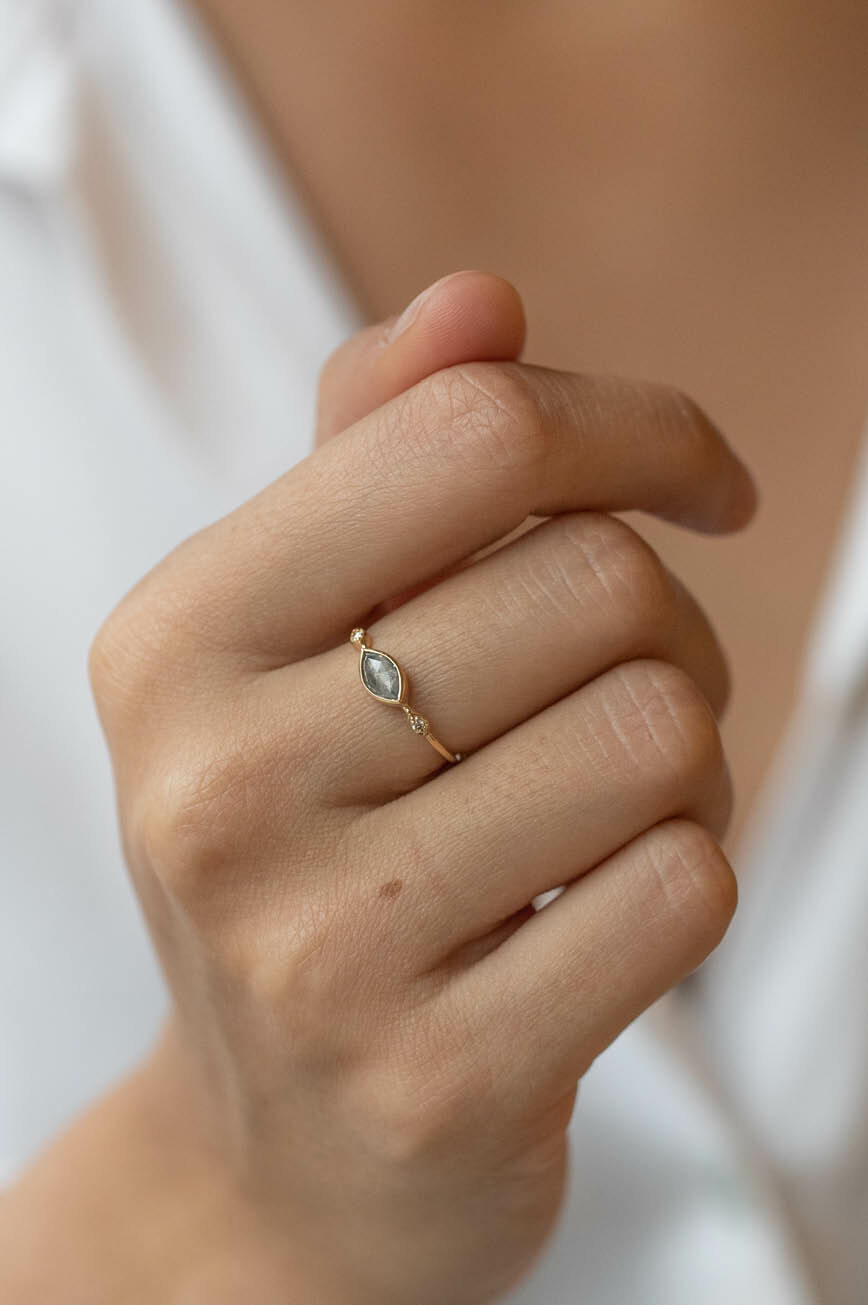 Yellow gold ring oval grey diamond two diamond eye accent slim band worn on hand Celine Daoust