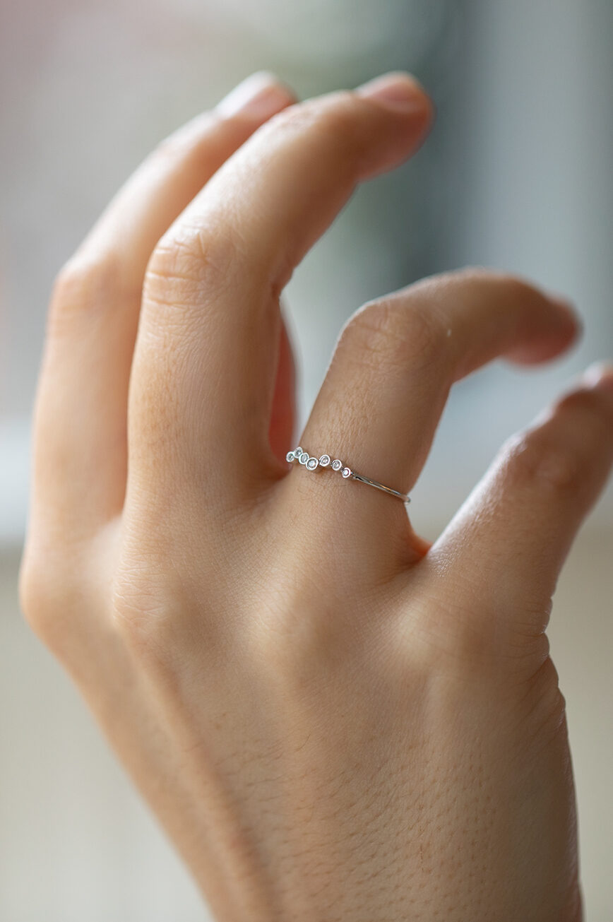 white gold ring with a twisted band design set with a continuous row of round brilliant diamonds along a delicate twisted wire
