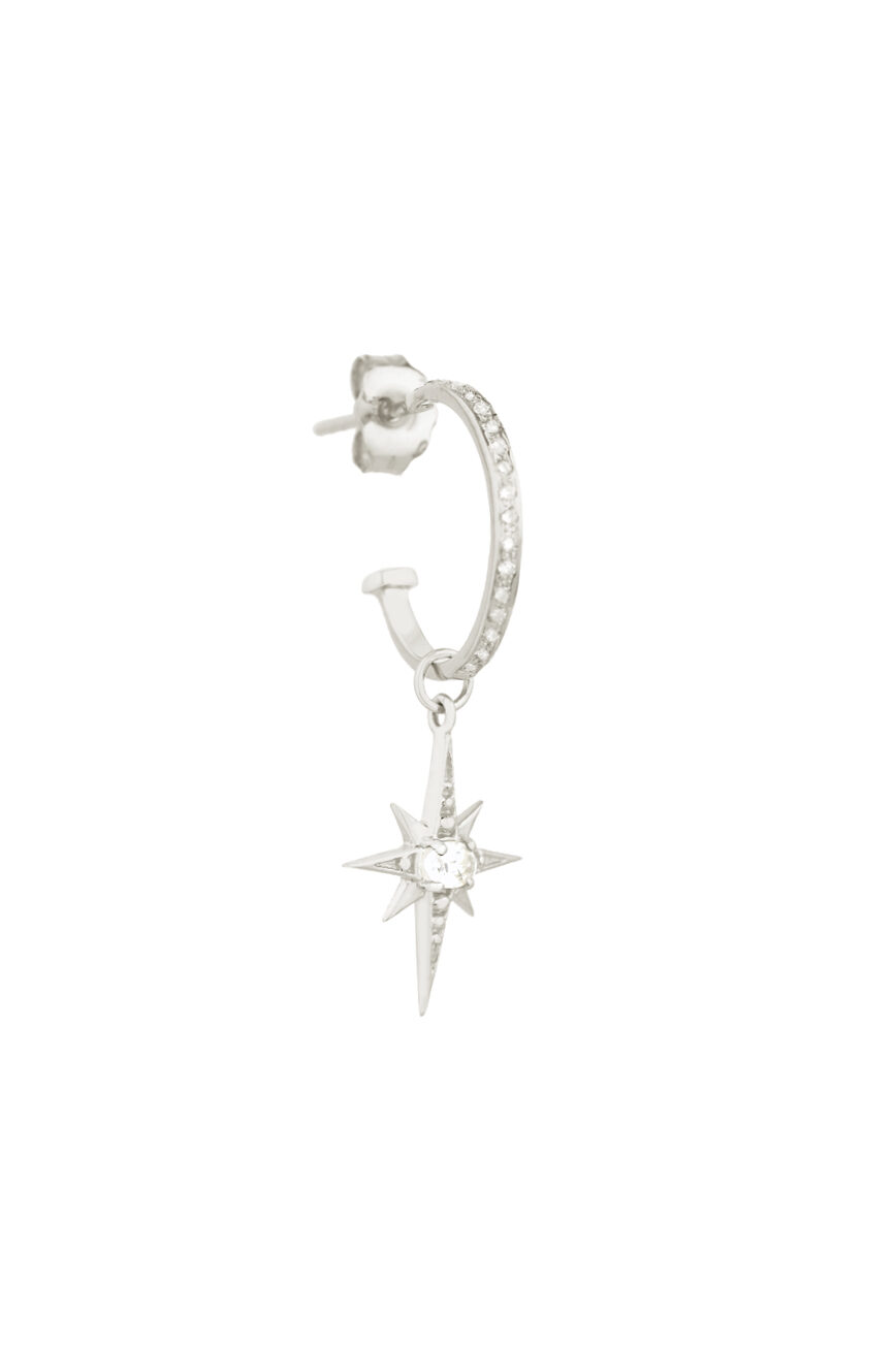 white gold single hoop earring pavé-set with diamonds, suspending a small eight-pointed north star charm set with a central white sapphire