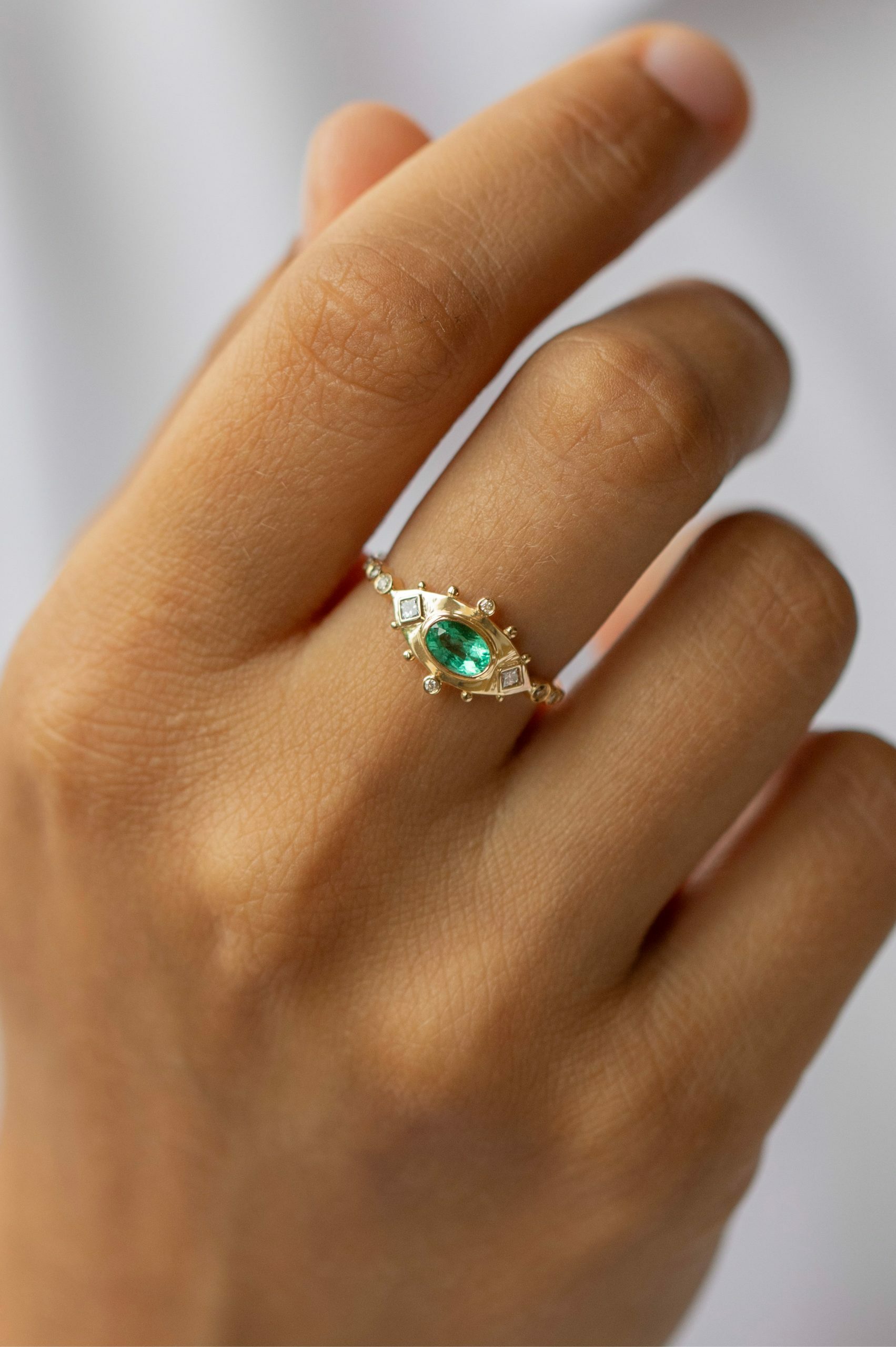 Yellow gold ring marquise emerald diamond eye motif accents Celine Daoust