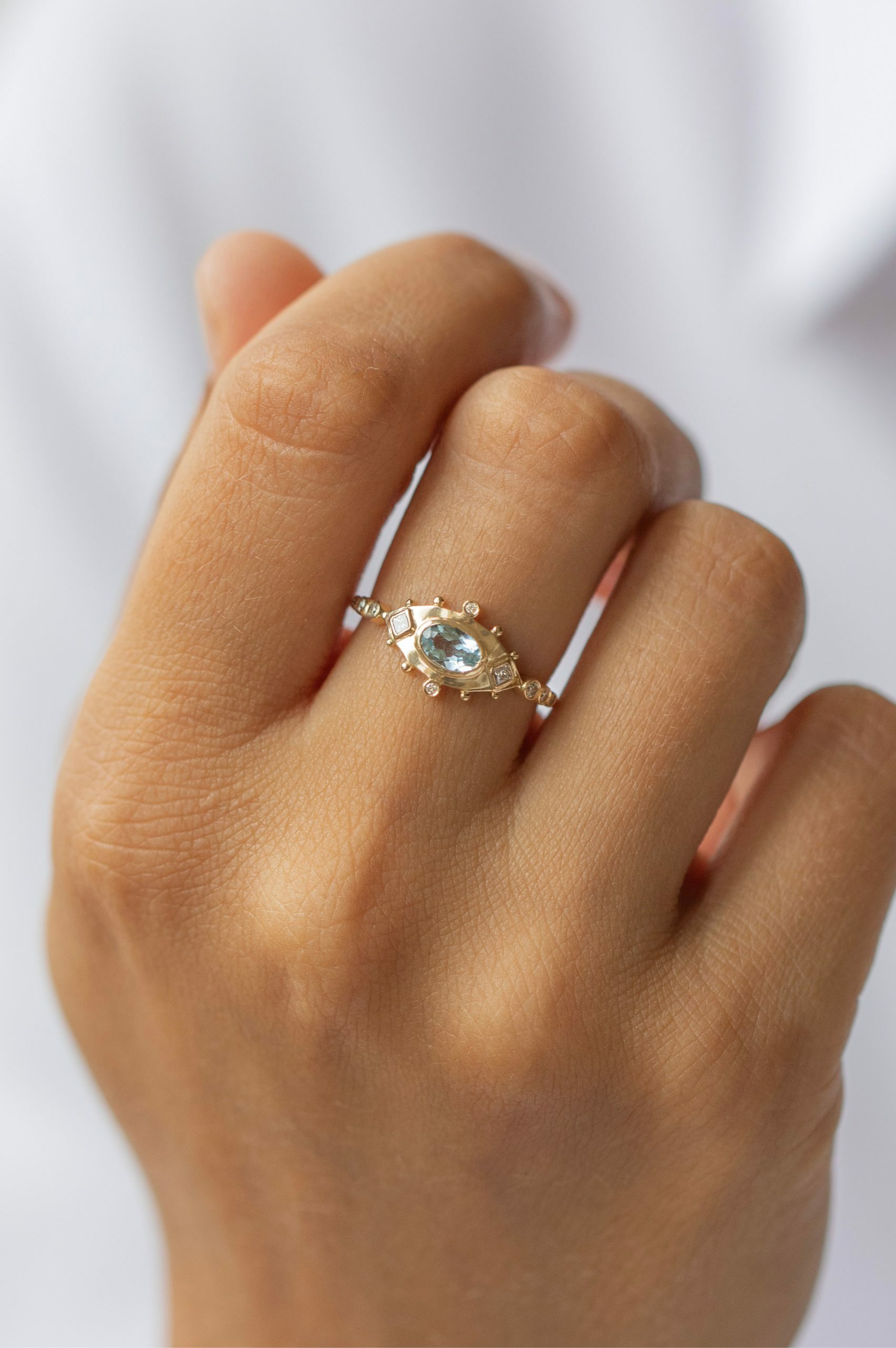 Yellow gold ring oval aquamarine diamond eye motif accents Celine Daoust