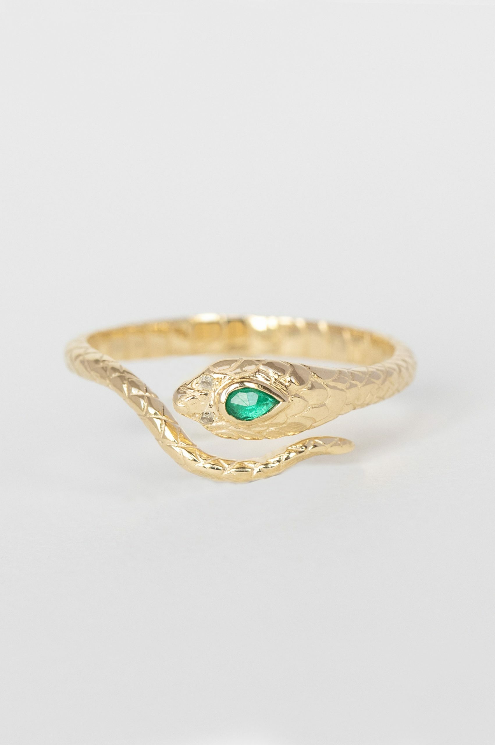 Yellow gold ring sculpted cobra motif pear emerald diamond accent Celine Daoust