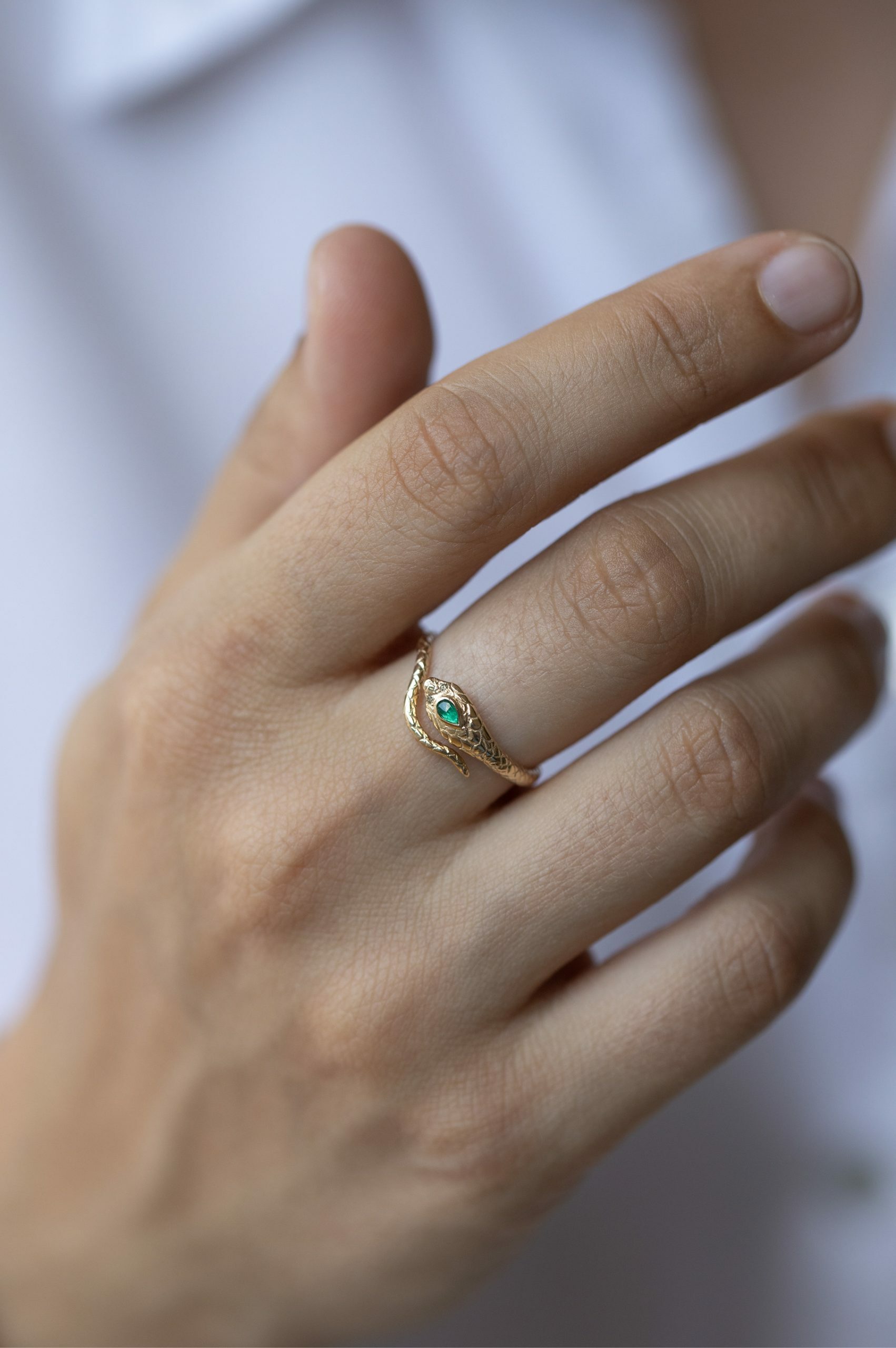 Yellow gold ring sculpted cobra motif pear emerald diamond accent Celine Daoust