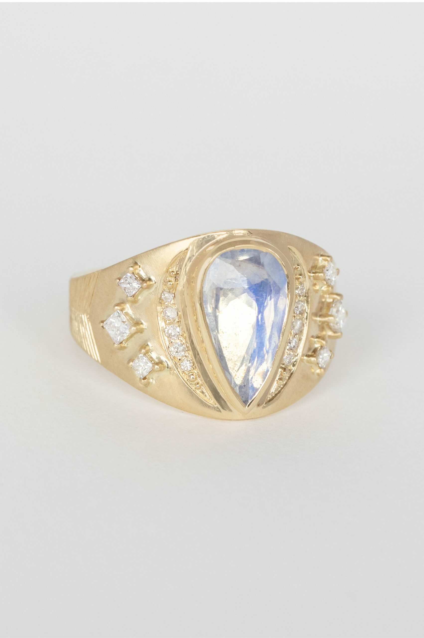 Gold signet ring pear moonstone diamond accents engraved band Céline Daoust