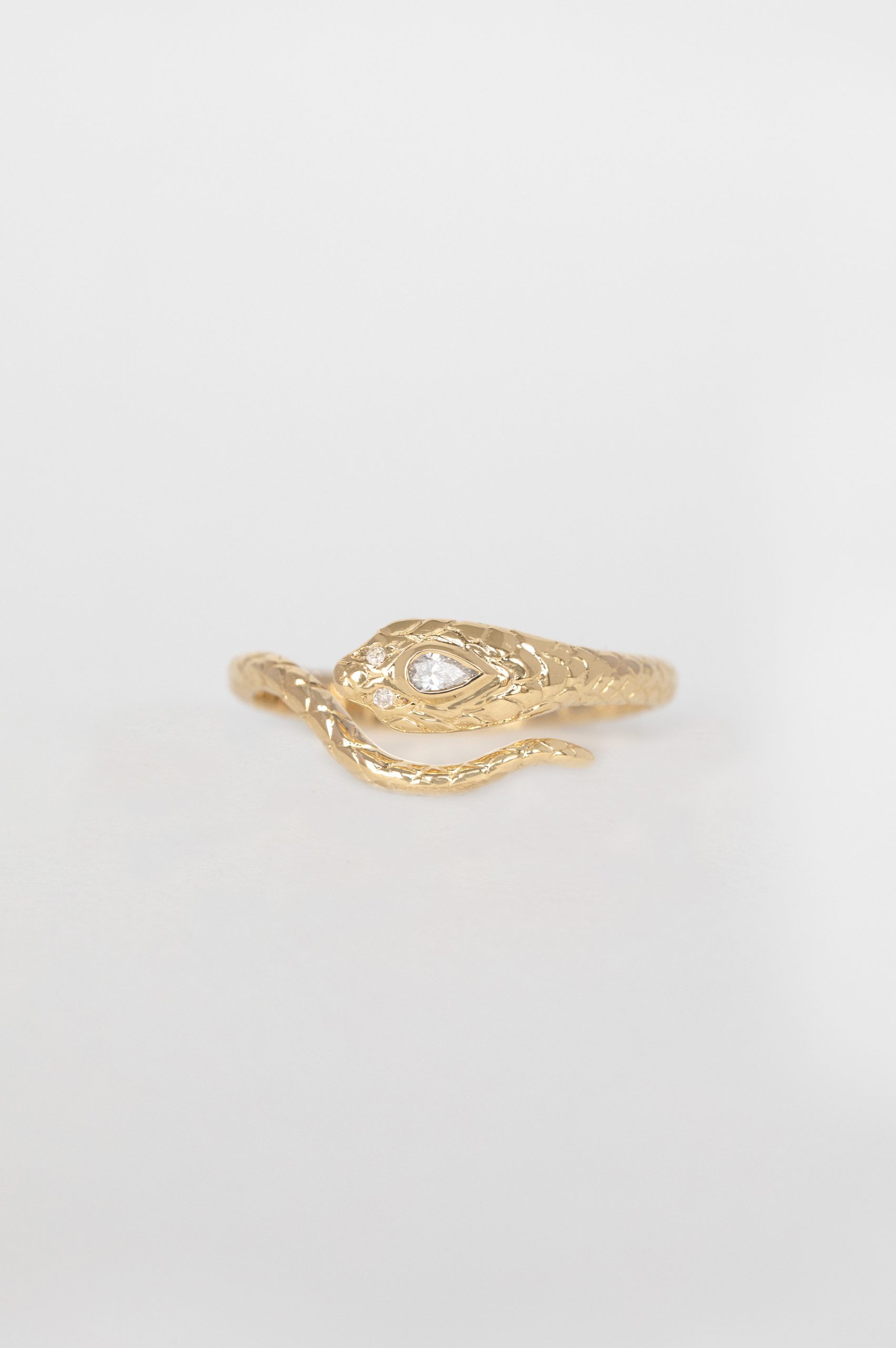 Gold ring sculpted cobra motif pear diamond white diamond accents Céline Daoust