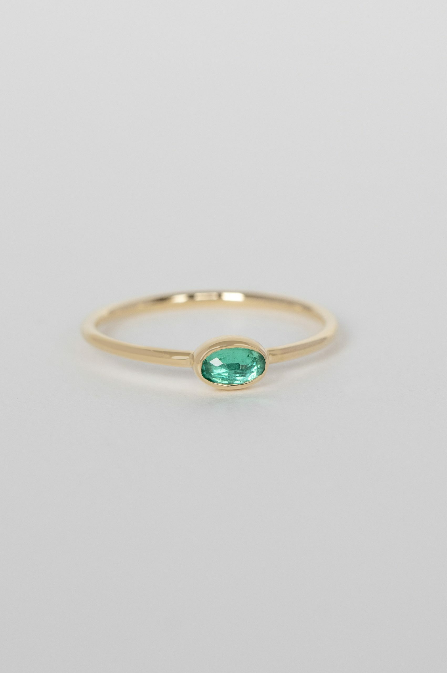 Yellow gold ring oval emerald bezel slim band Celine Daoust