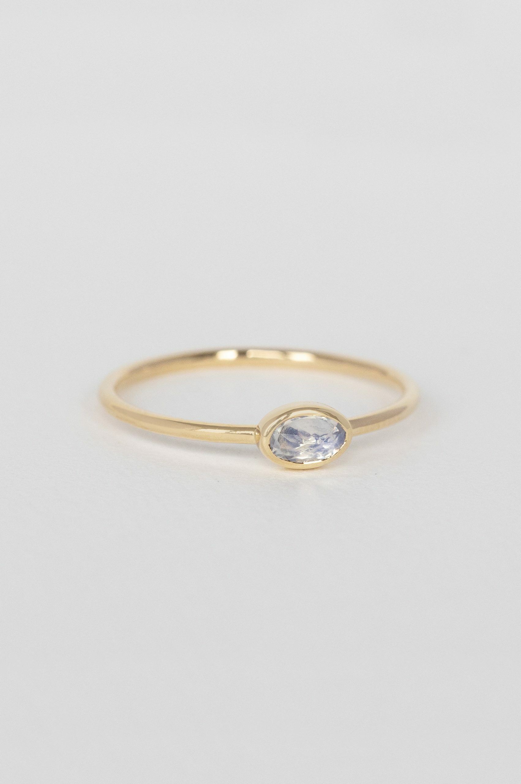 Yellow gold ring oval moonstone bezel slim band Celine Daoust