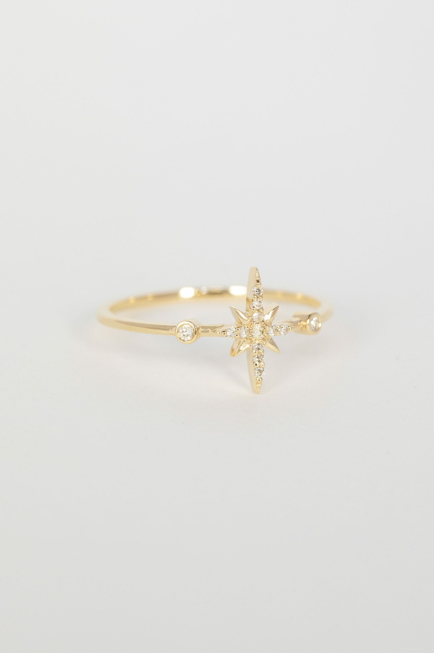 Yellow gold ring north star diamond motif diamond accent slim band Celine Daoust