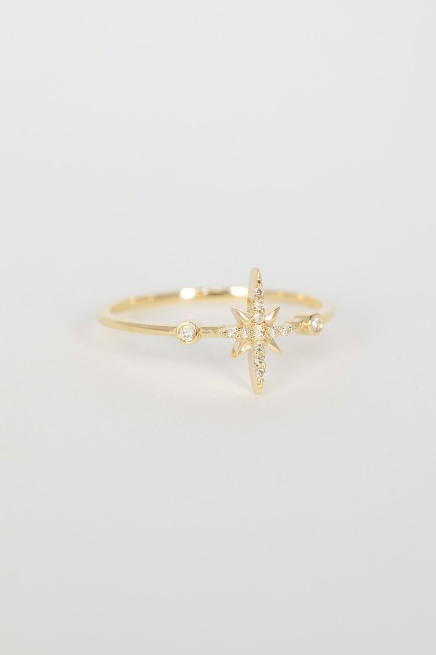 Yellow gold ring north star diamond motif diamond accent slim band Celine Daoust