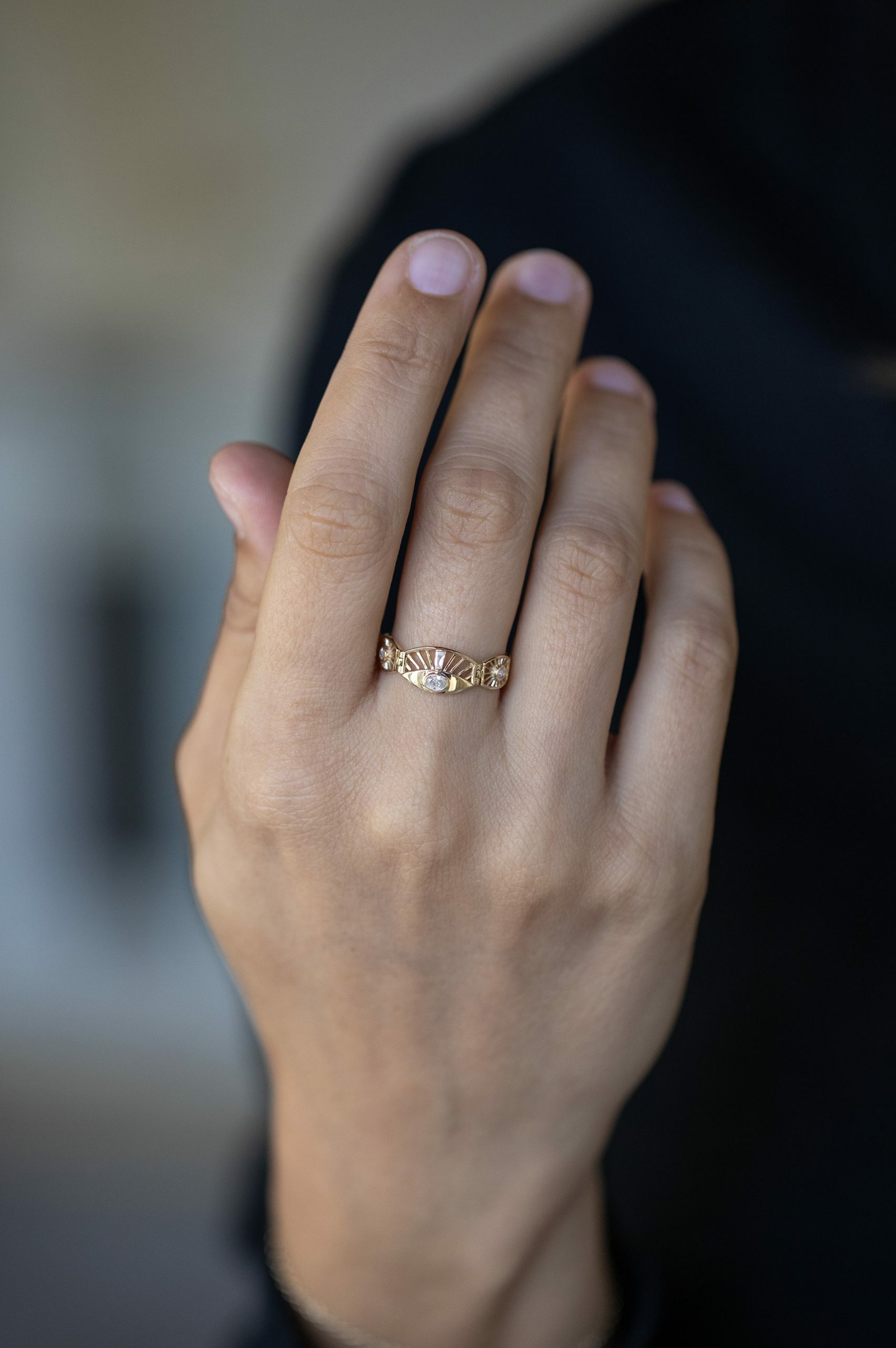 Yellow gold wide articulated ring oval diamond sun ray eye motif baguette accents Celine Daoust
