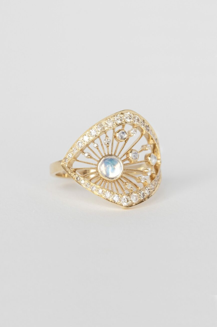 Yellow gold wide ring round moonstone open filigree frame pavé diamond border Celine Daoust