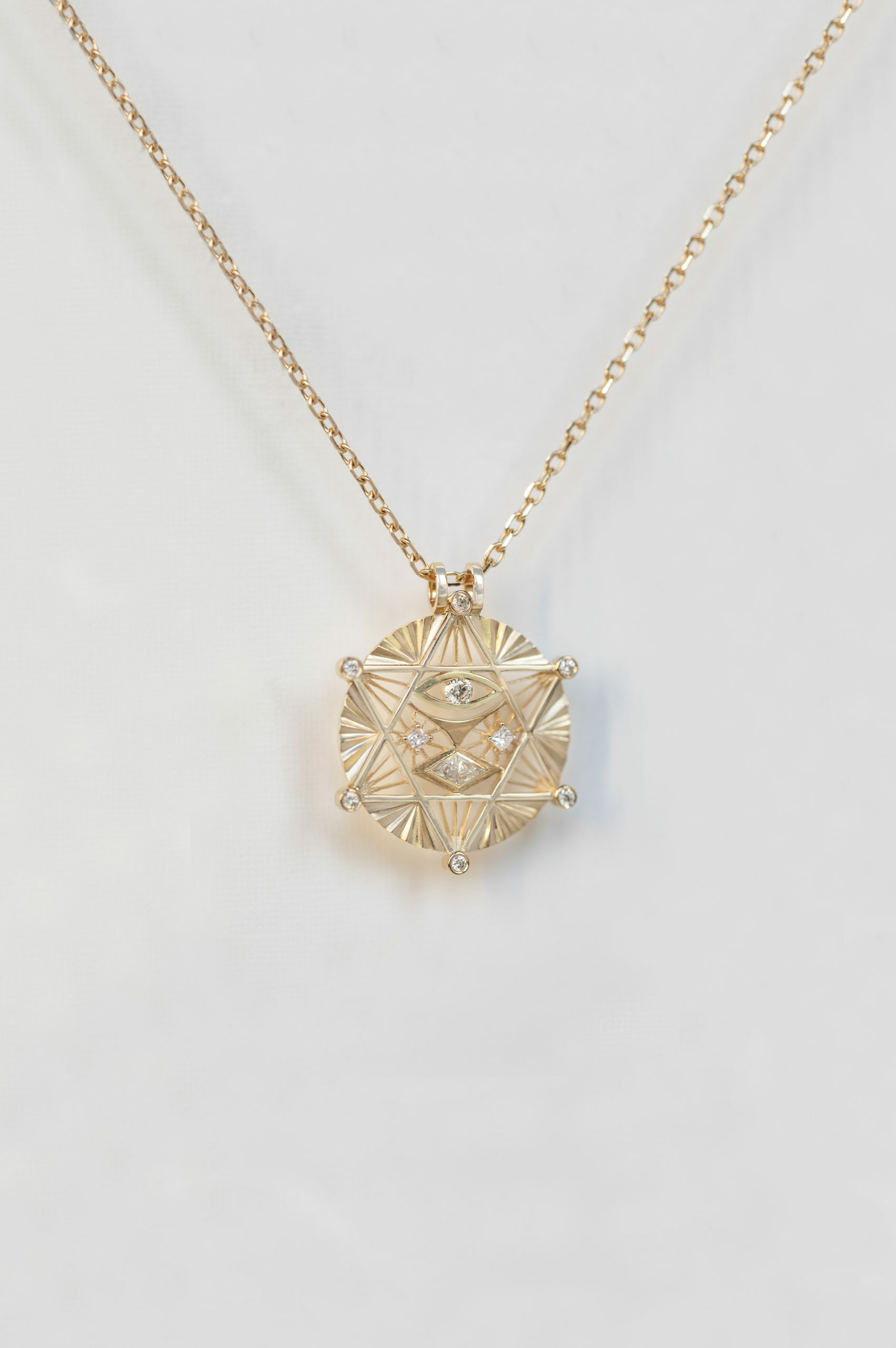 Gold necklace large merkabah star medal diamond accents eye motif Celine Daoust
