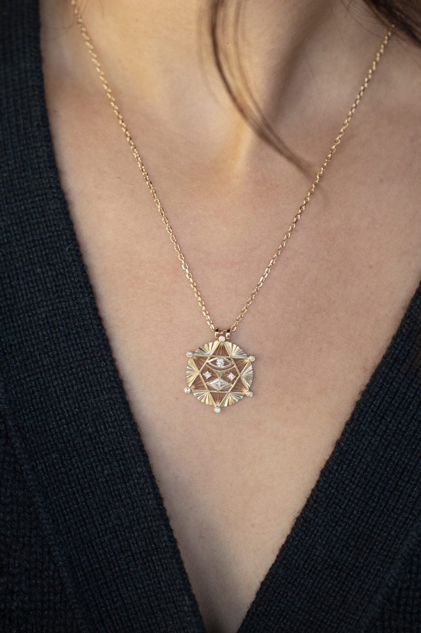 Gold necklace large merkabah star medal diamond accents eye motif Celine Daoust