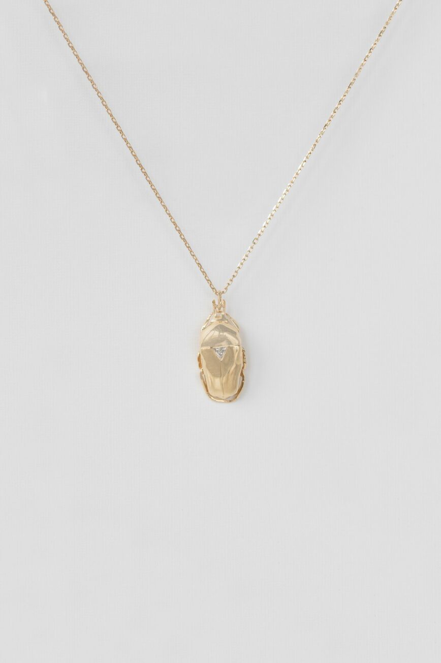 Yellow gold necklace sculpted scarab pendant trillion diamond accent chain Celine Daoust