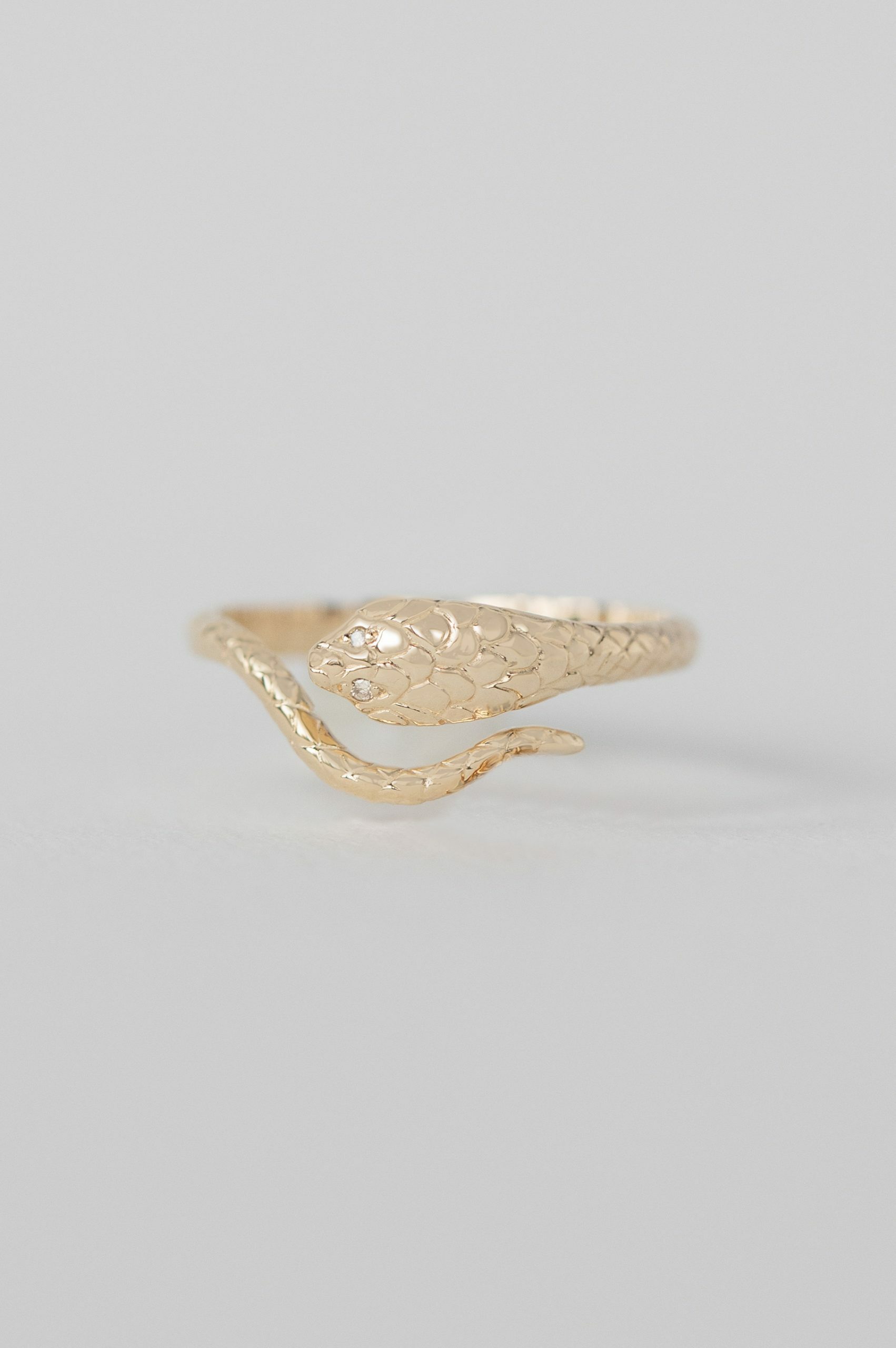 Gold ring sculpted cobra motif engraved band diamond accent Celine Daoust