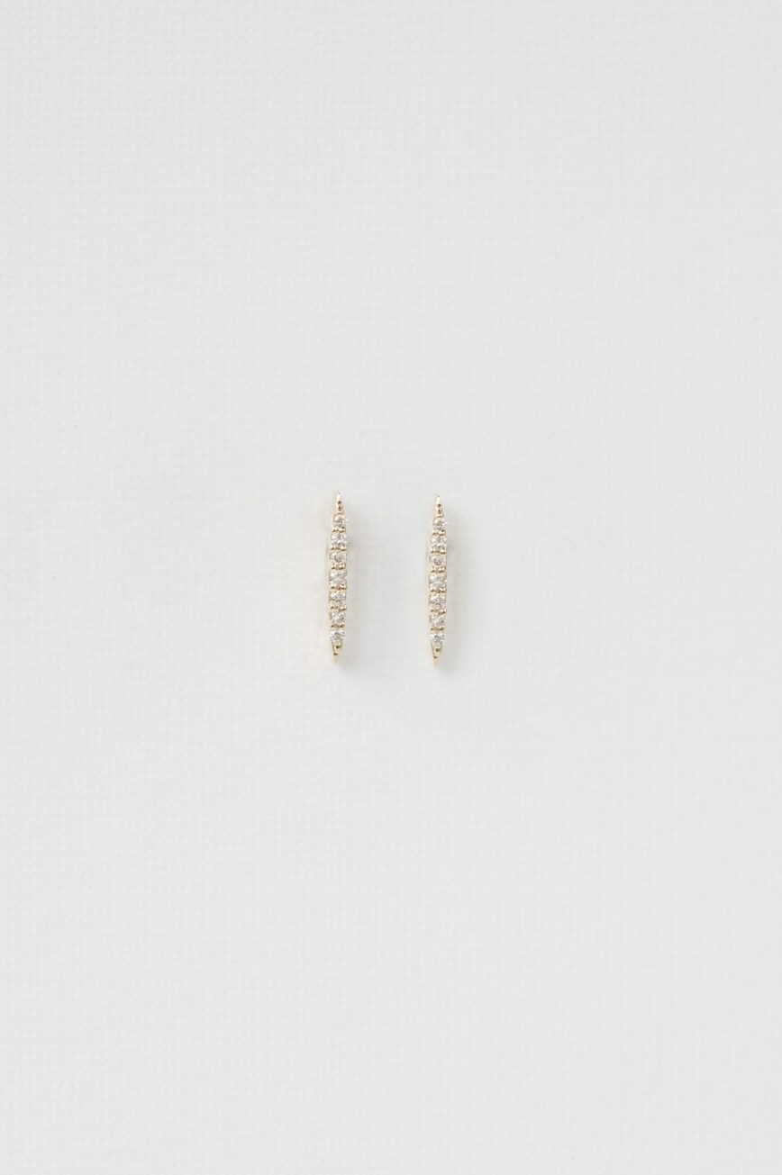 yellow gold linear bar stud earrings set with a vertical row of small pavé diamonds, slim and architectural