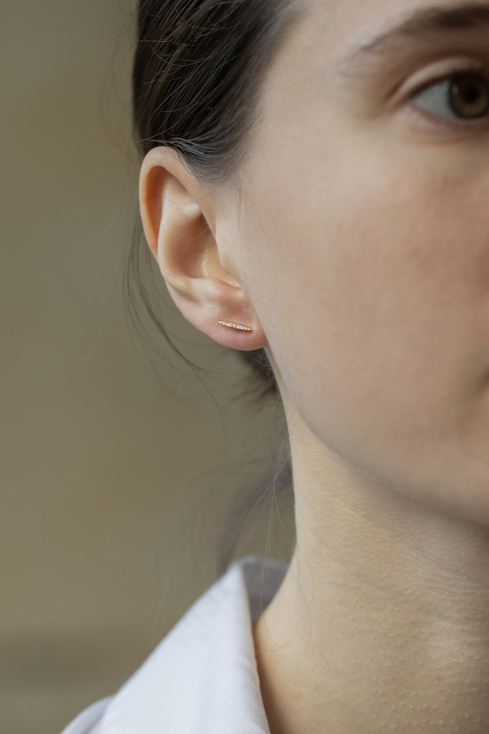 yellow gold linear bar stud earrings set with a vertical row of small pavé diamonds, slim and architectural