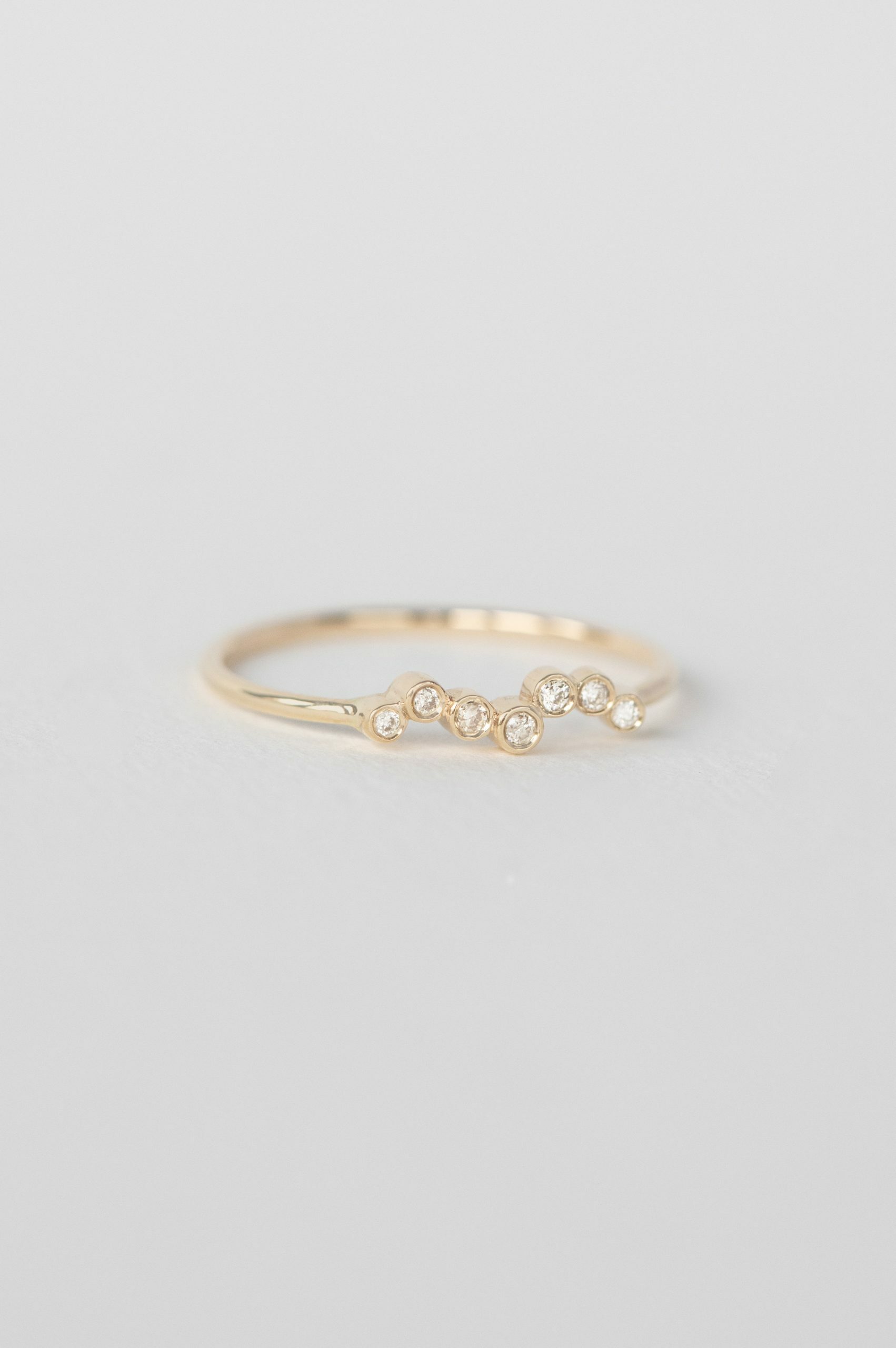 Yellow gold ring multiple bezel-set diamonds twisted slim band Celine Daoust