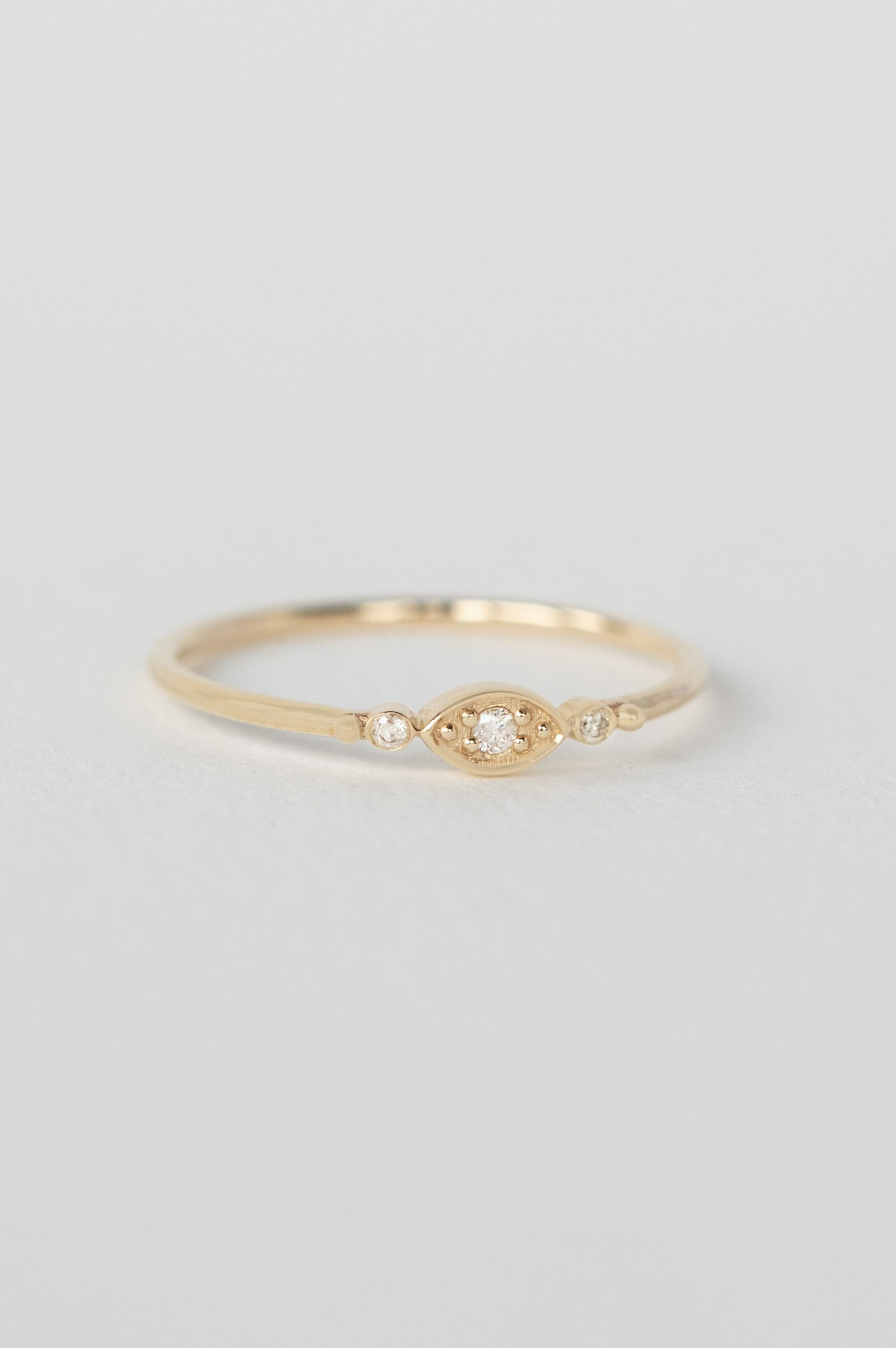 Gold ring oval diamond eye motif bezel set band Céline Daoust