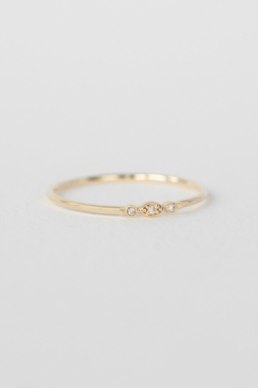 Gold ring three tiny diamonds eye motif slim band Celine Daoust