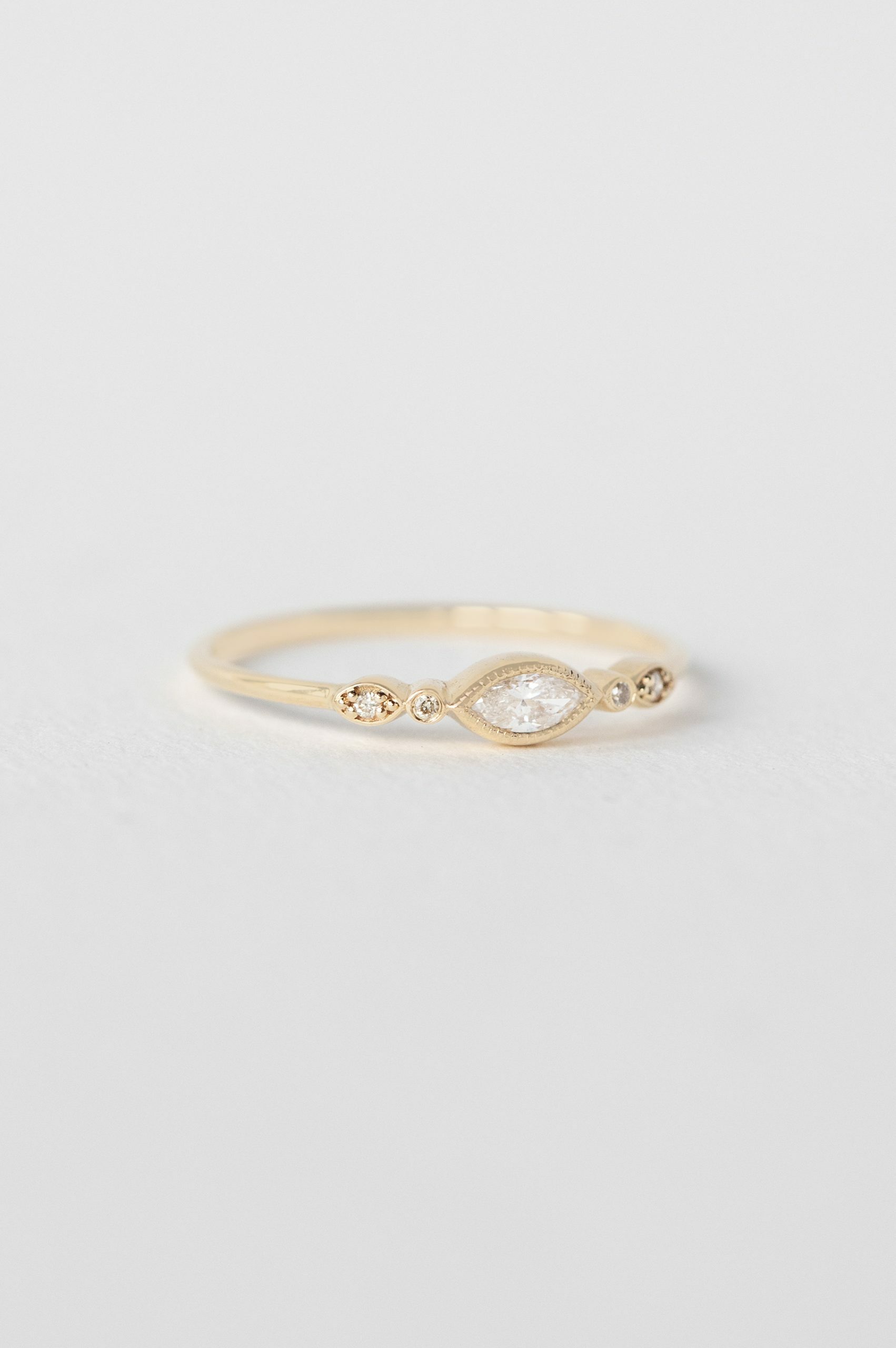 Yellow gold ring marquise diamond two diamond eye accent slim band Celine Daoust