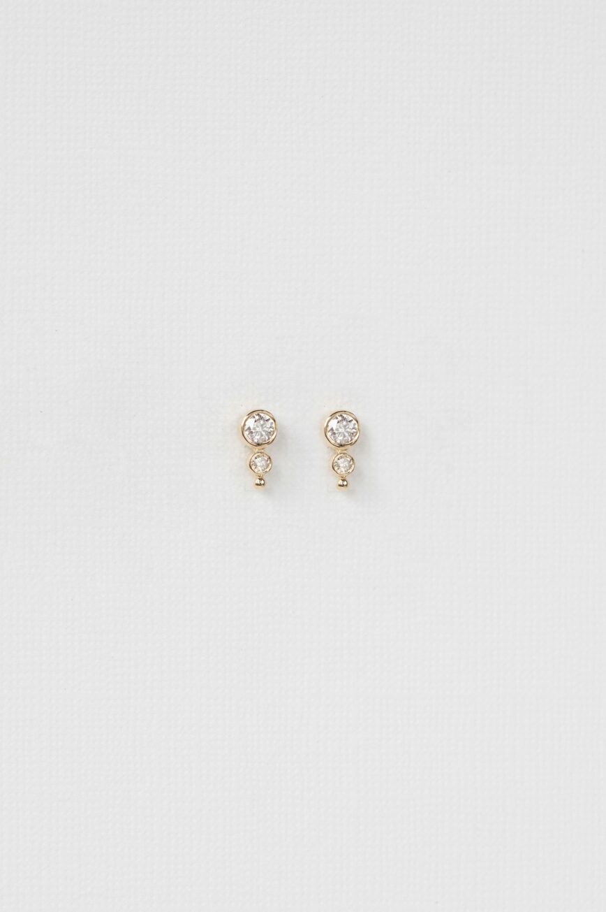 yellow gold drop earrings each with a bezel-set round diamond at top suspending a smaller diamond drop, simple and elegant