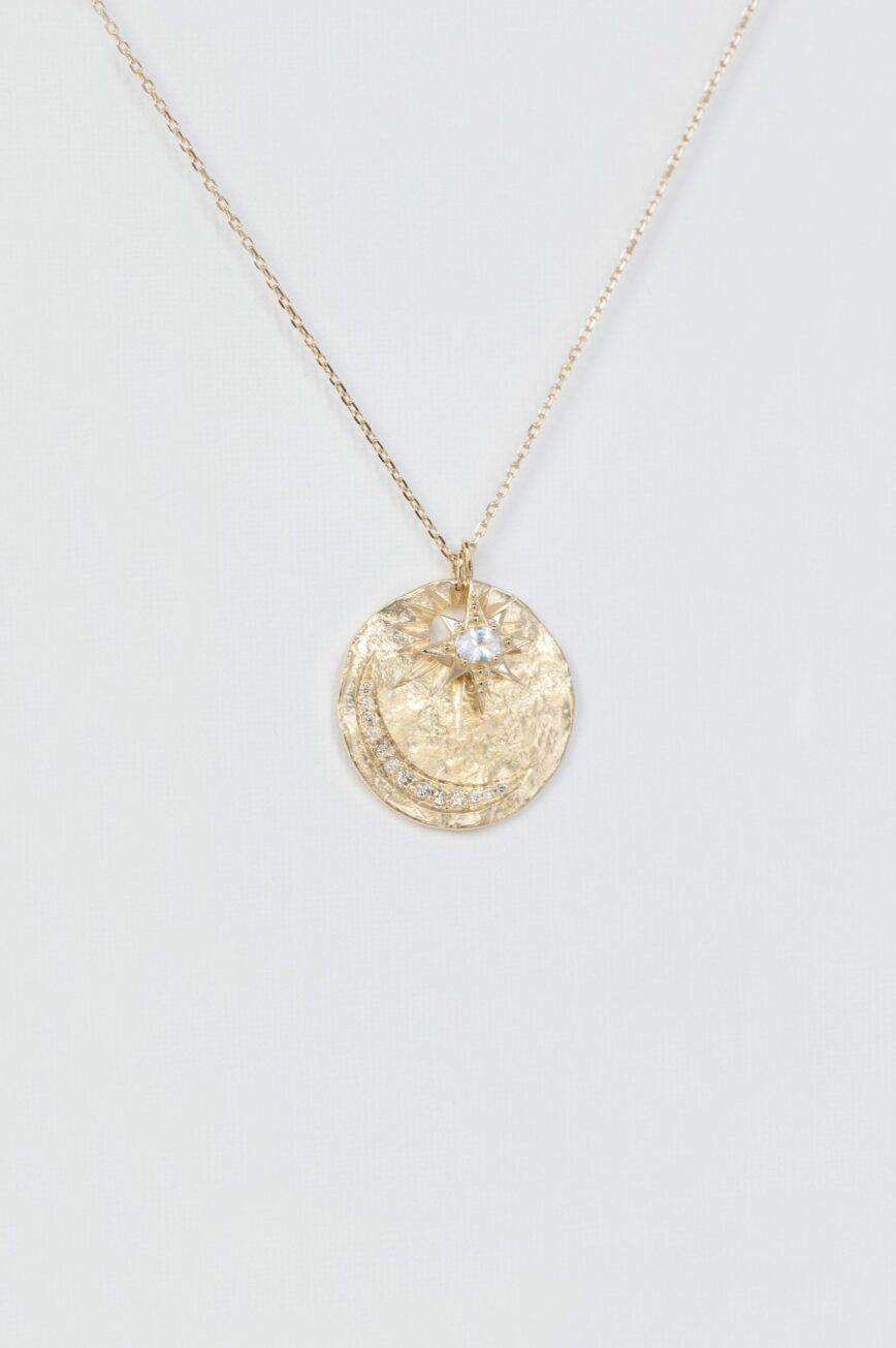 Yellow gold necklace round textured medal pendant diamond sapphire star moon eye motif Celine Daoust