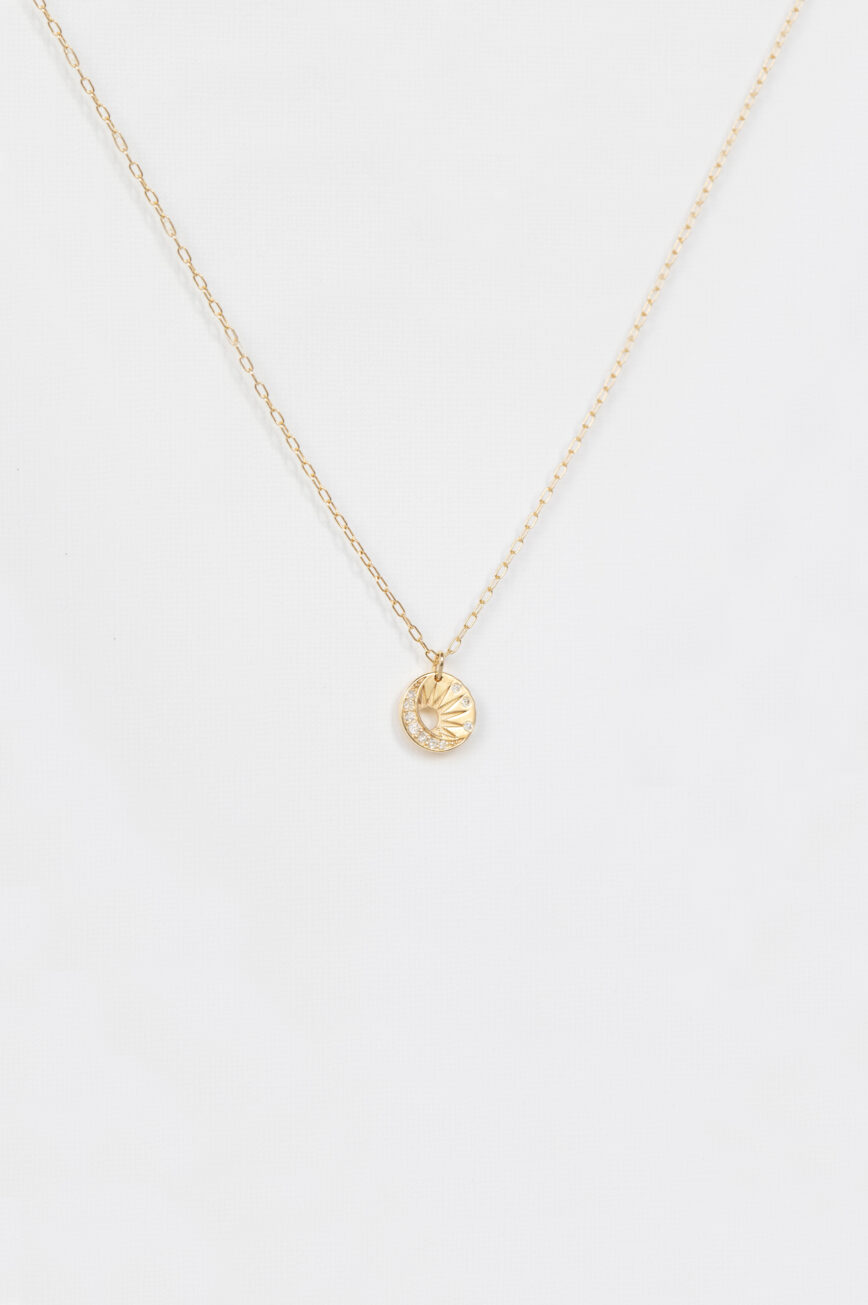 Yellow gold necklace small round medal pendant sun moon motif delicate chain Celine Daoust