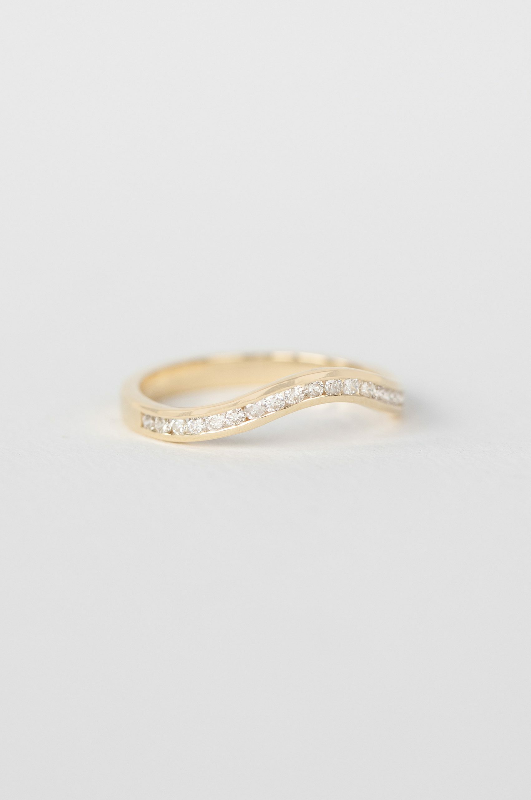 Gold wave ring pavé diamond rail setting curved band Céline Daoust