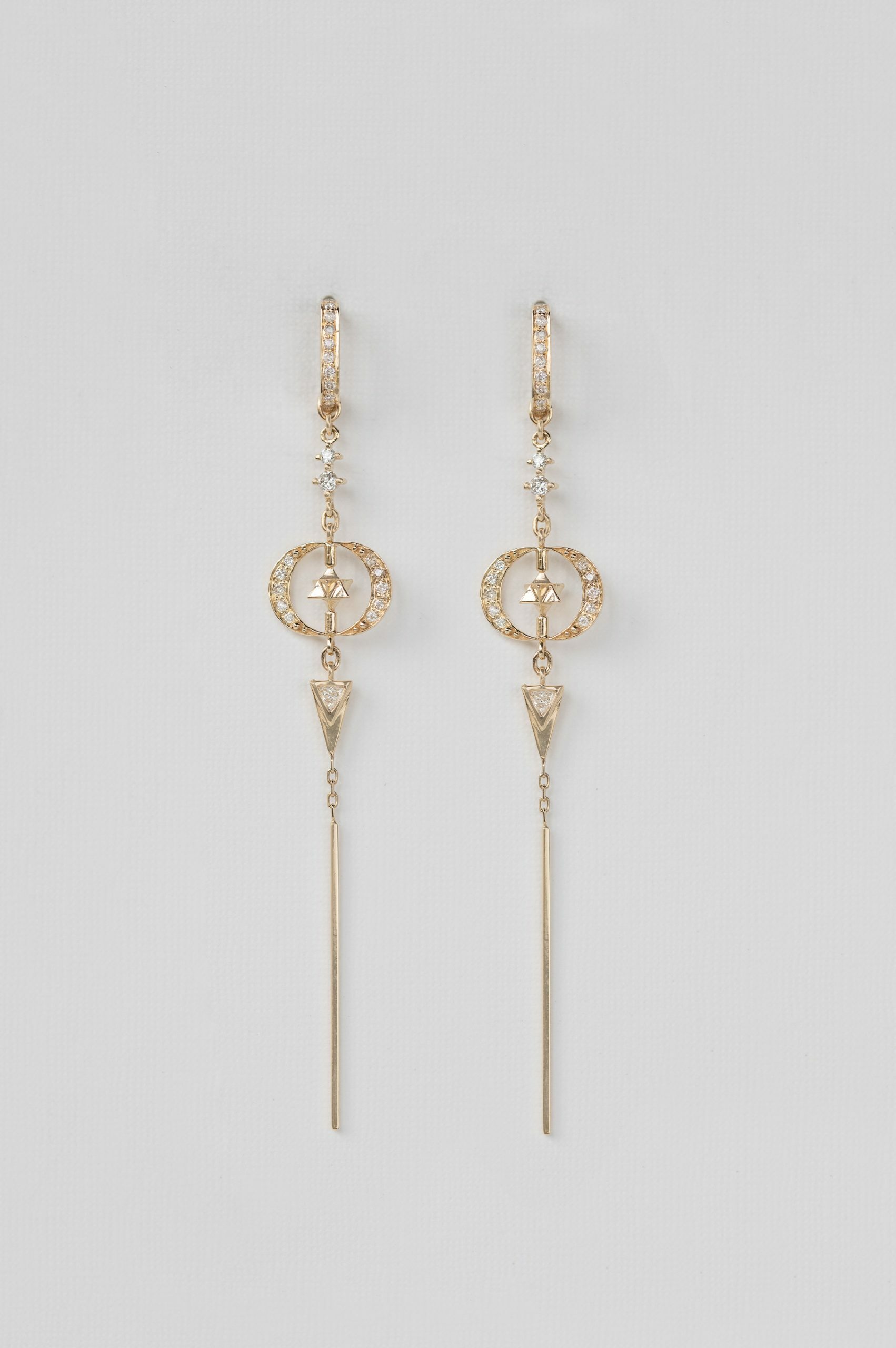 Yellow gold long drop earrings moon merkabah diamond charms worn on ear Celine Daoust