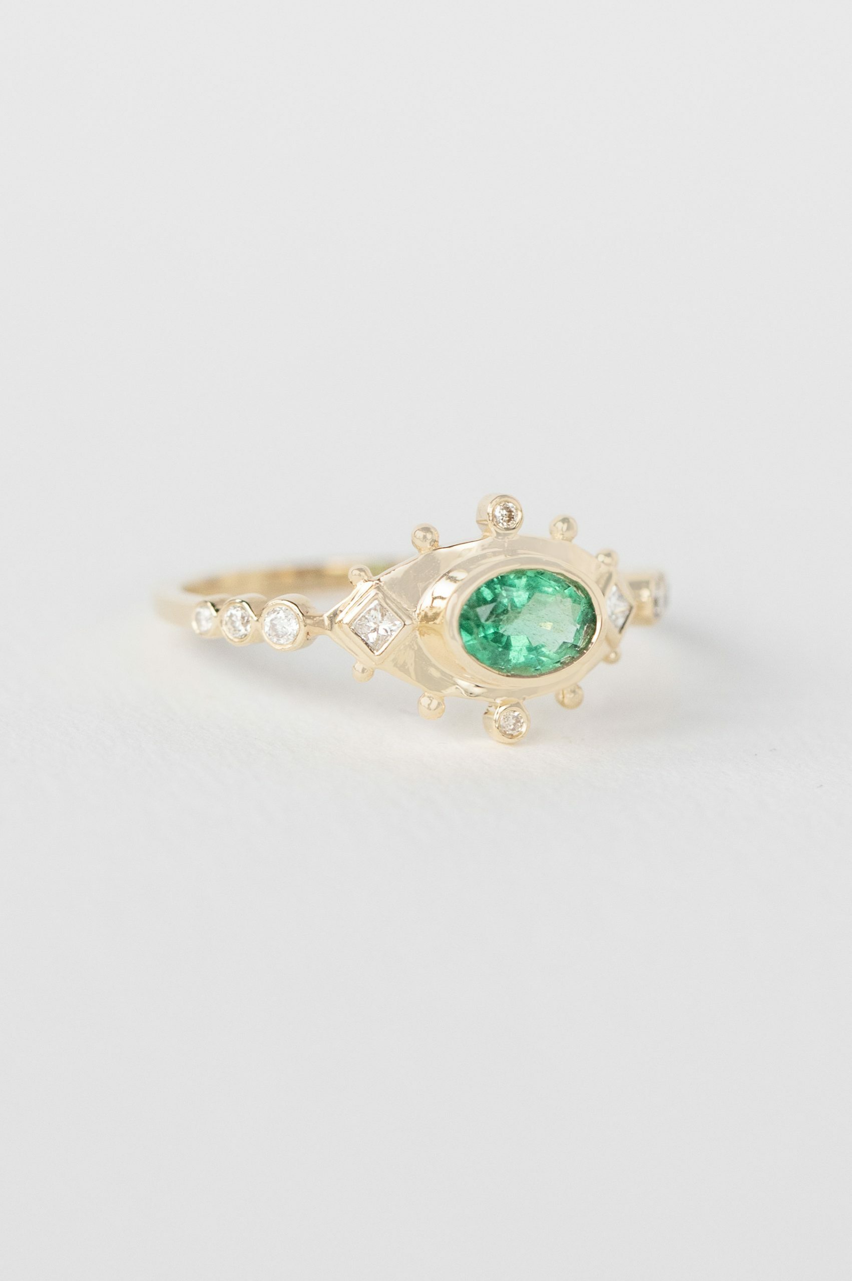 Yellow gold ring marquise emerald diamond eye motif accents Celine Daoust